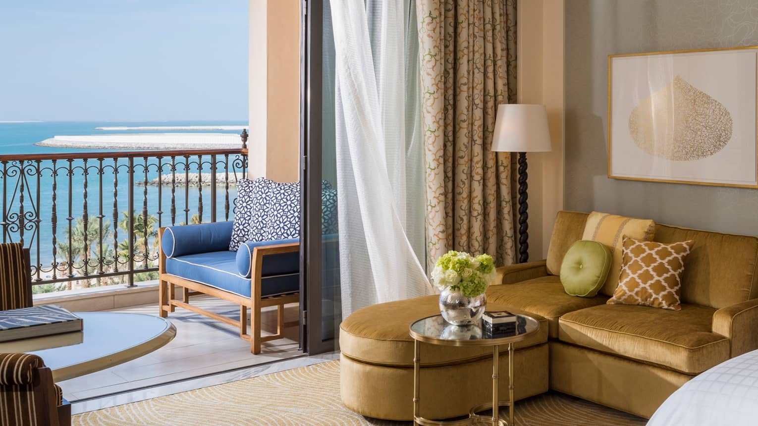Premier Sea-View Room with L-shaped gold sofa beside oversized sliding glass door to balcony