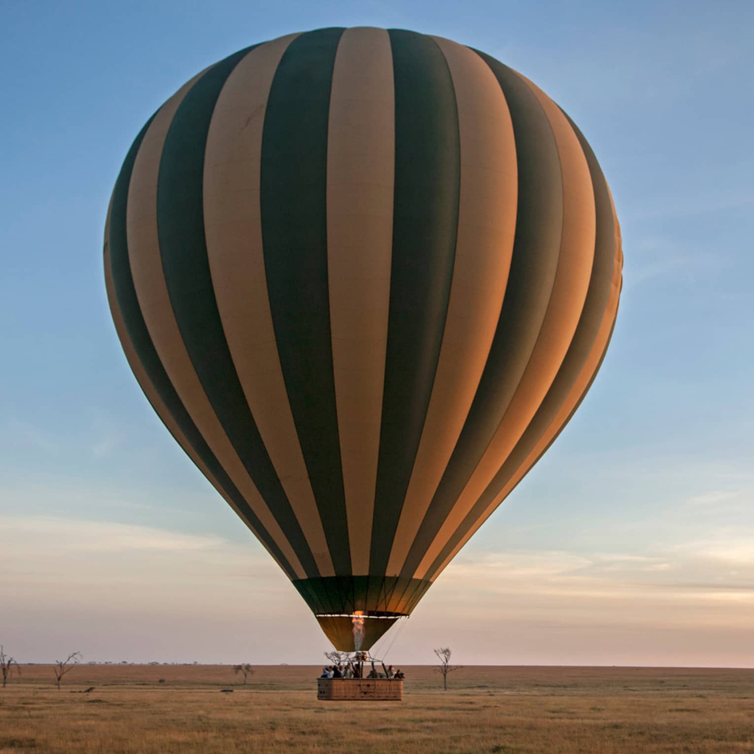 A hot air balloon ride at sunset