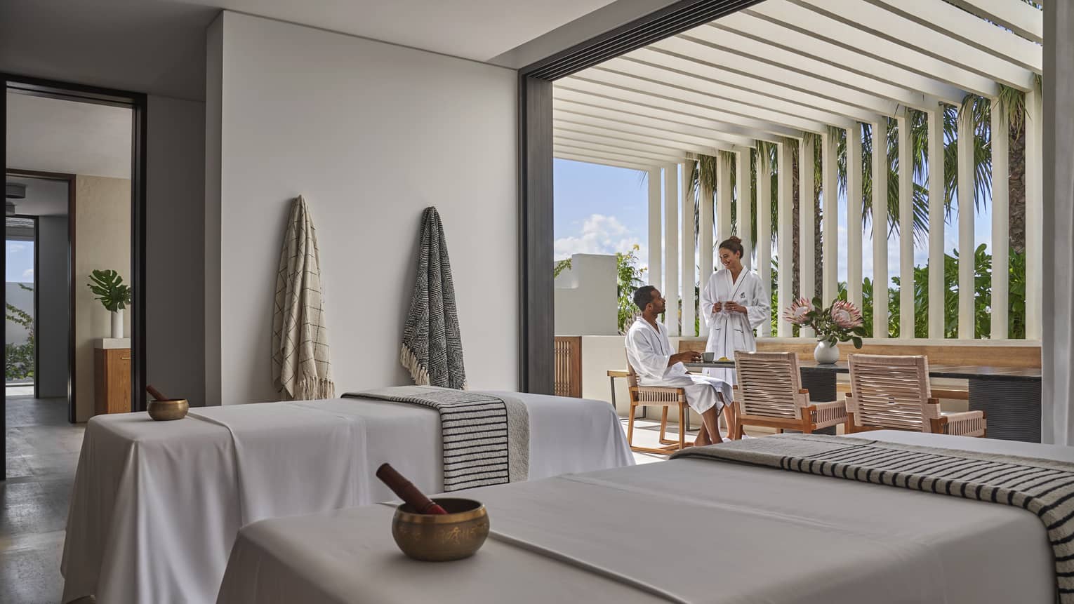 A man and woman relaxing in a spa room while talking.