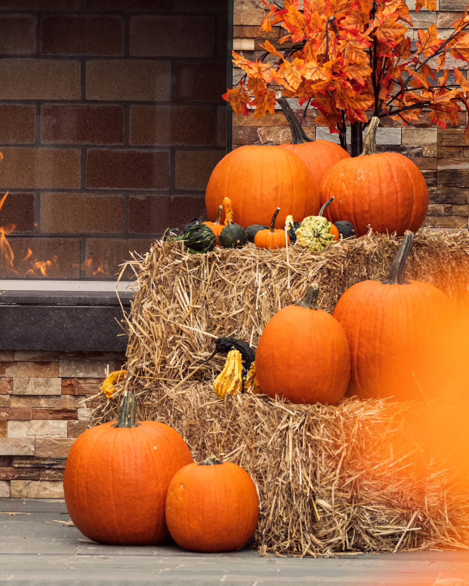 Pumpkins stacked on top of hay bales