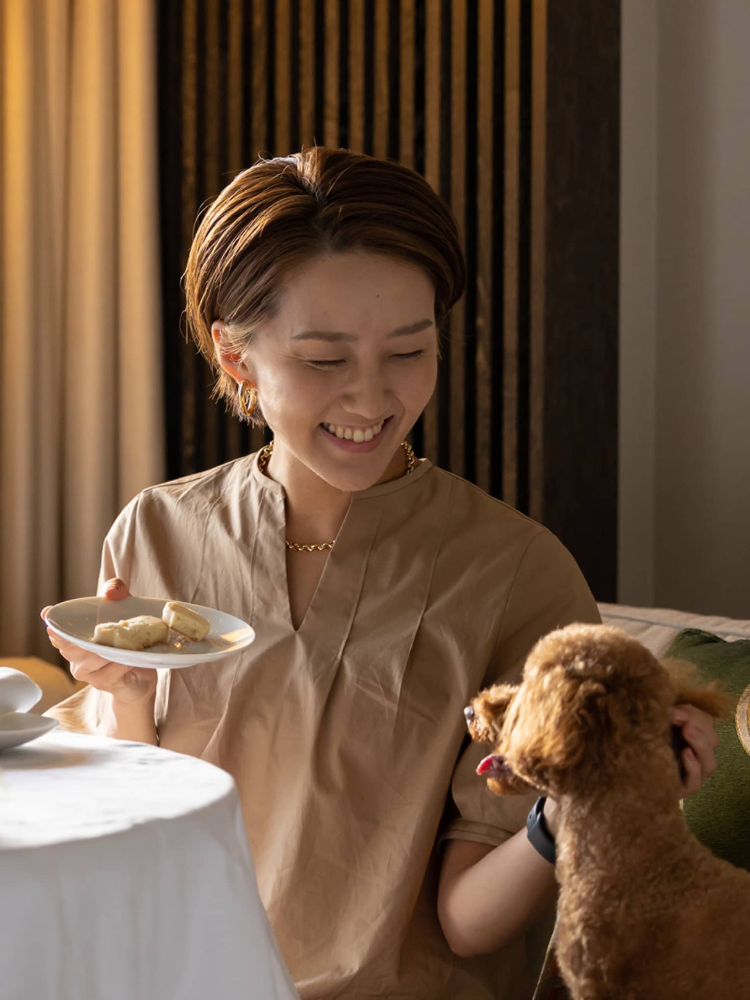 Female guest enjoys in-room dining with her toy poodle