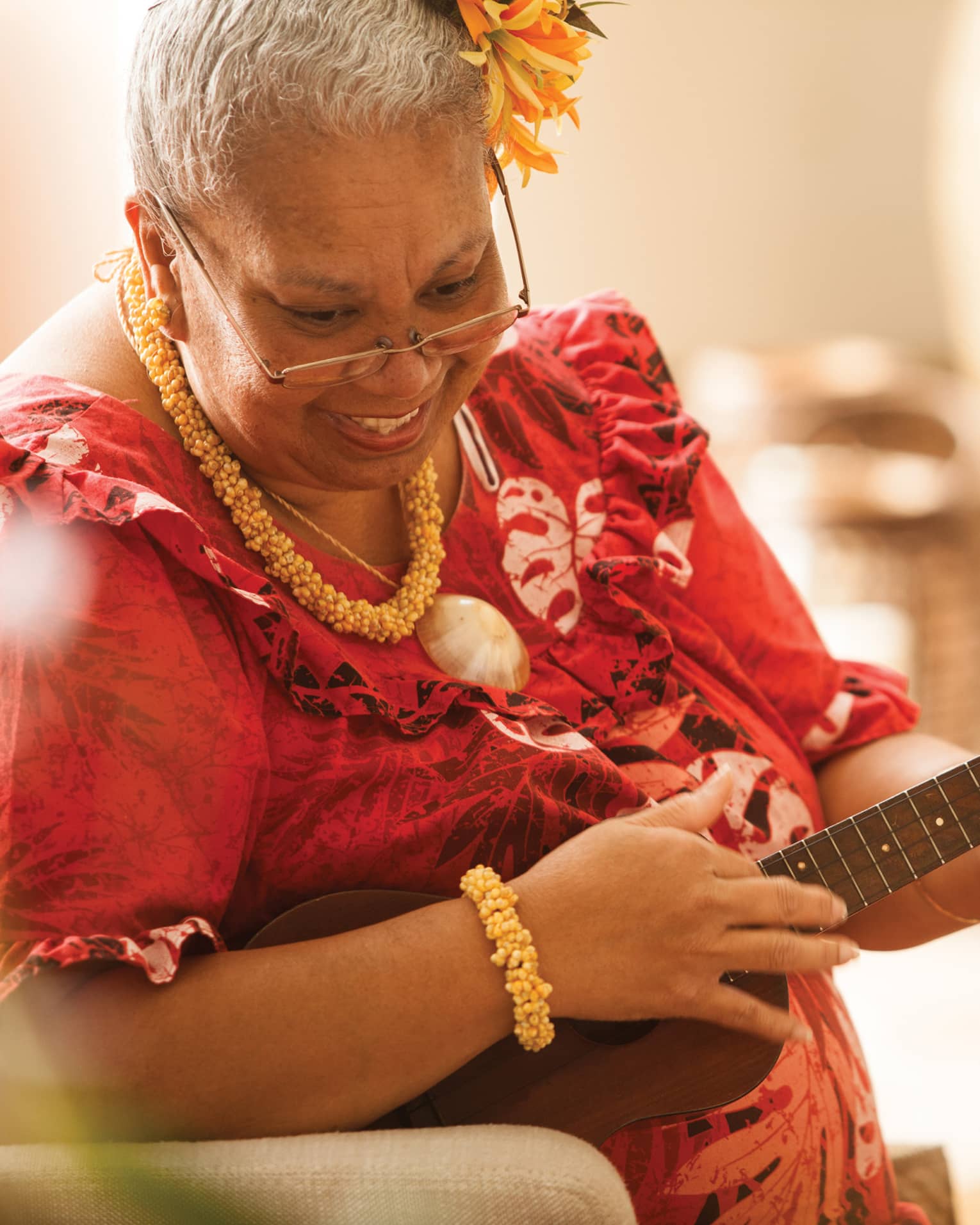 Close-up of Hawaiian elder playing ukulele