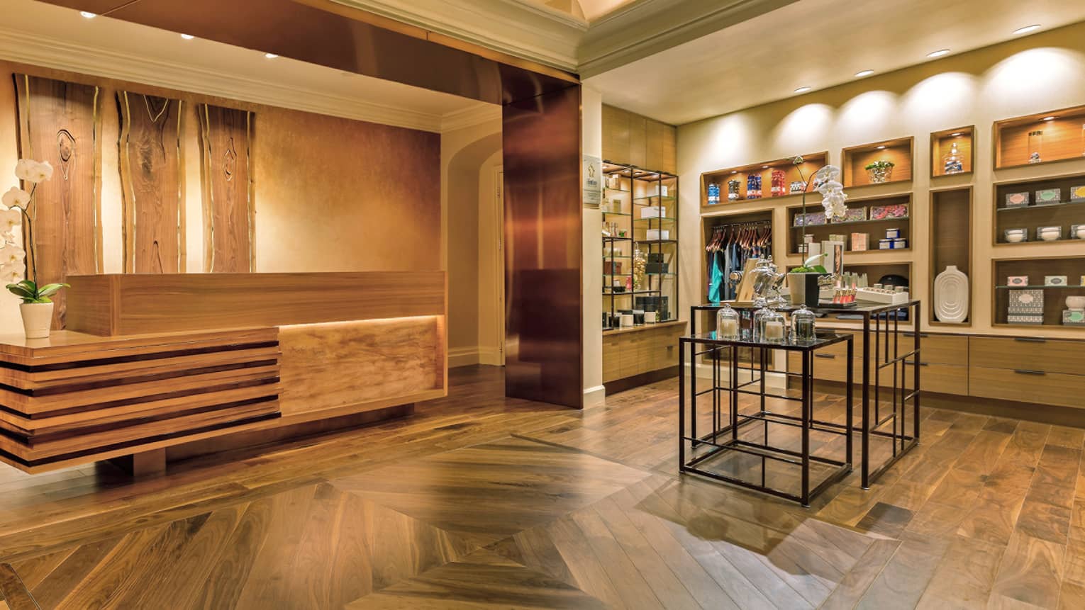 Spa reception area with wood floors, deck, rustic wood panels on wall, retail section