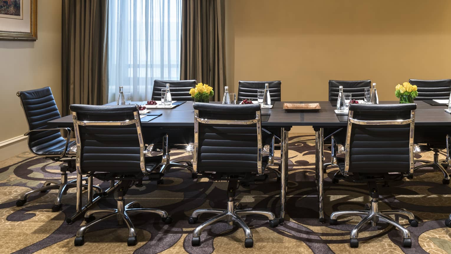 Long boardroom meeting table with leather swivel chairs 