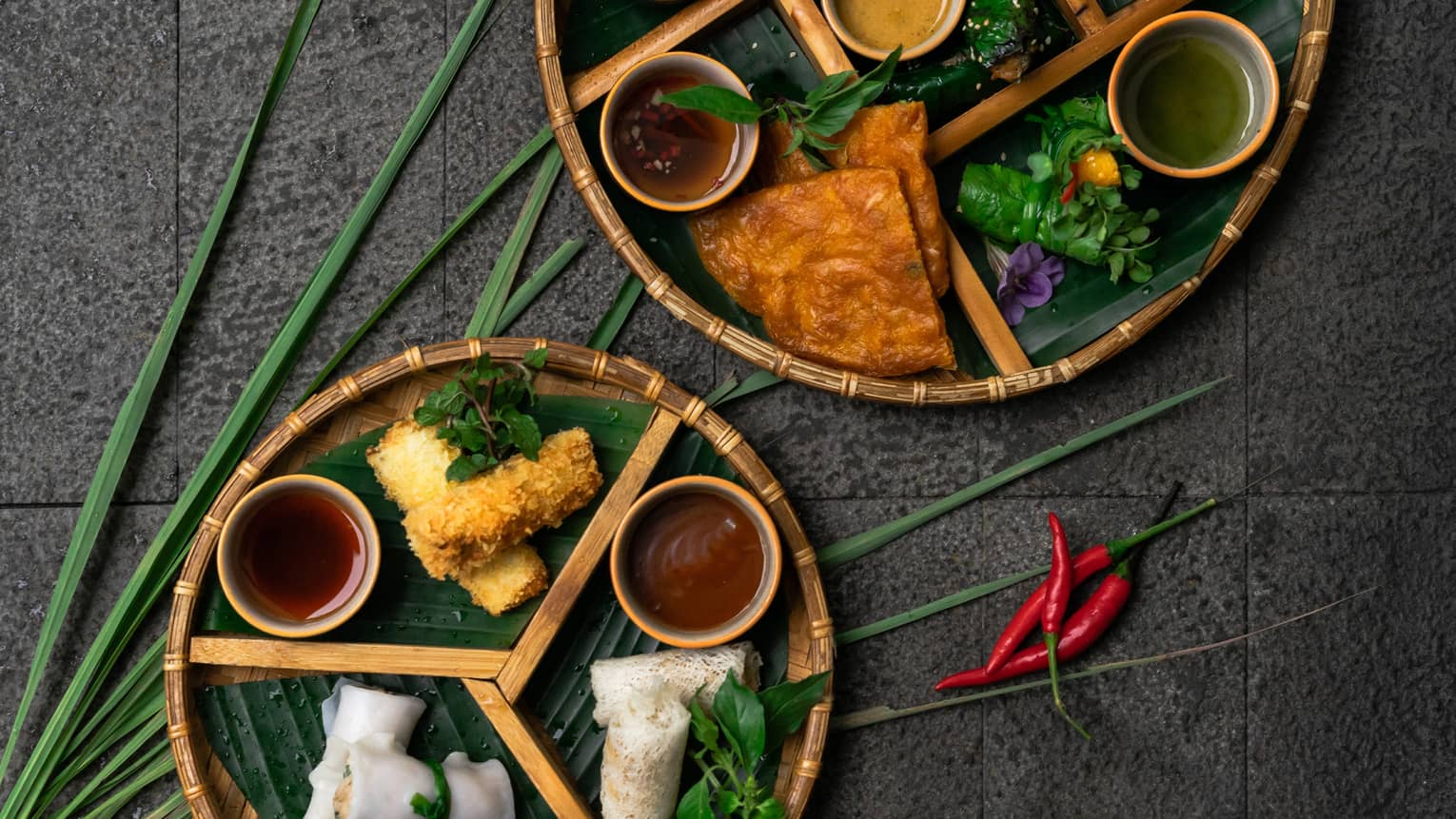 Vietnamese rice pancake with beef wrapped in a lot leaf, prawns, crab and calamari spring rolls