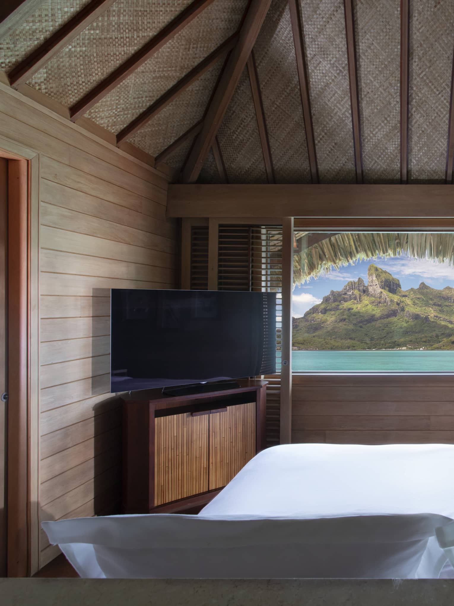 Lagoon and mountain view from a teak-walled guest room