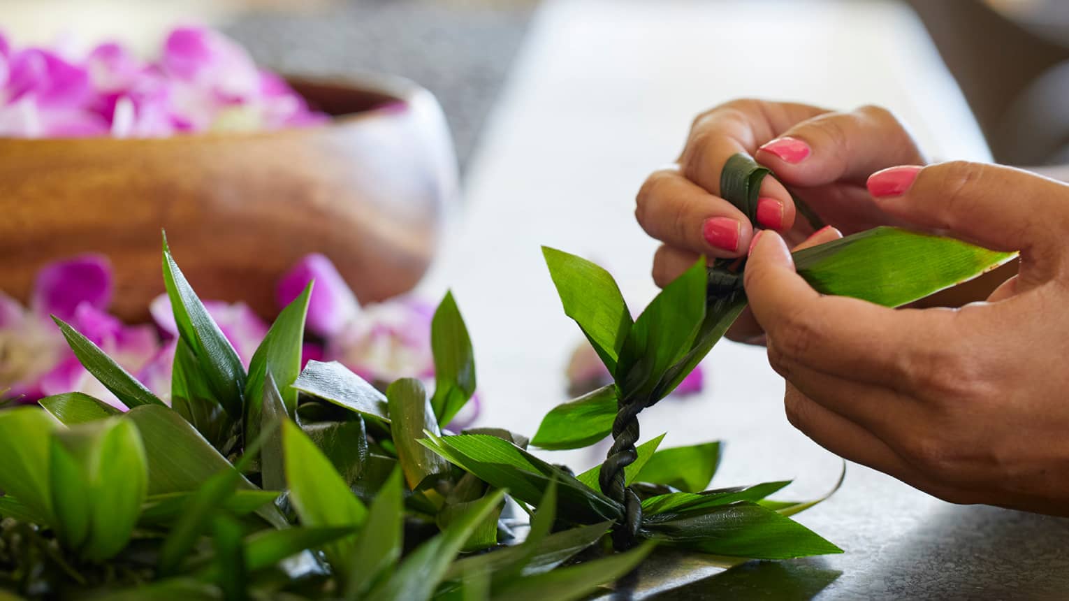 Guests weave leis out of fresh materials