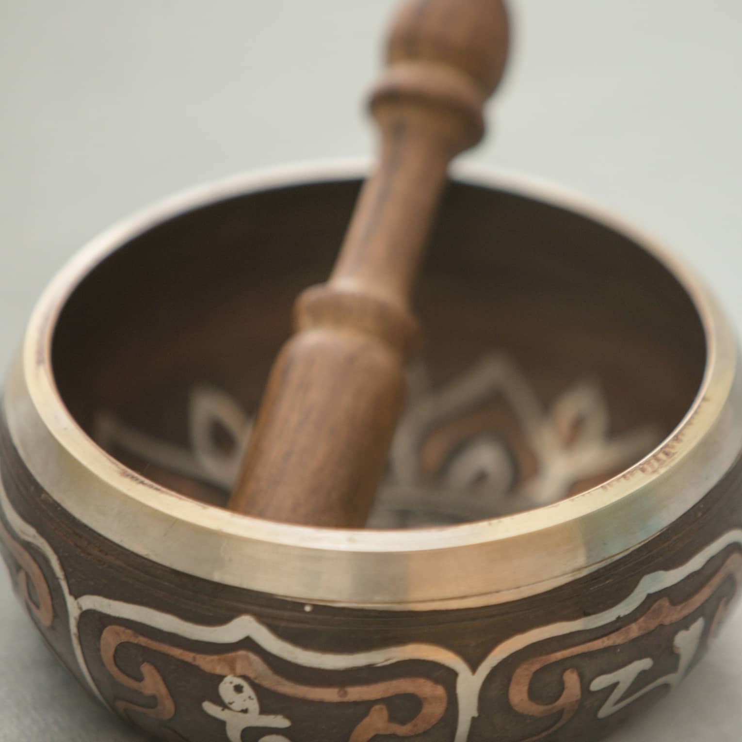 Small copper and wood bowl with decorative design, wood pestle