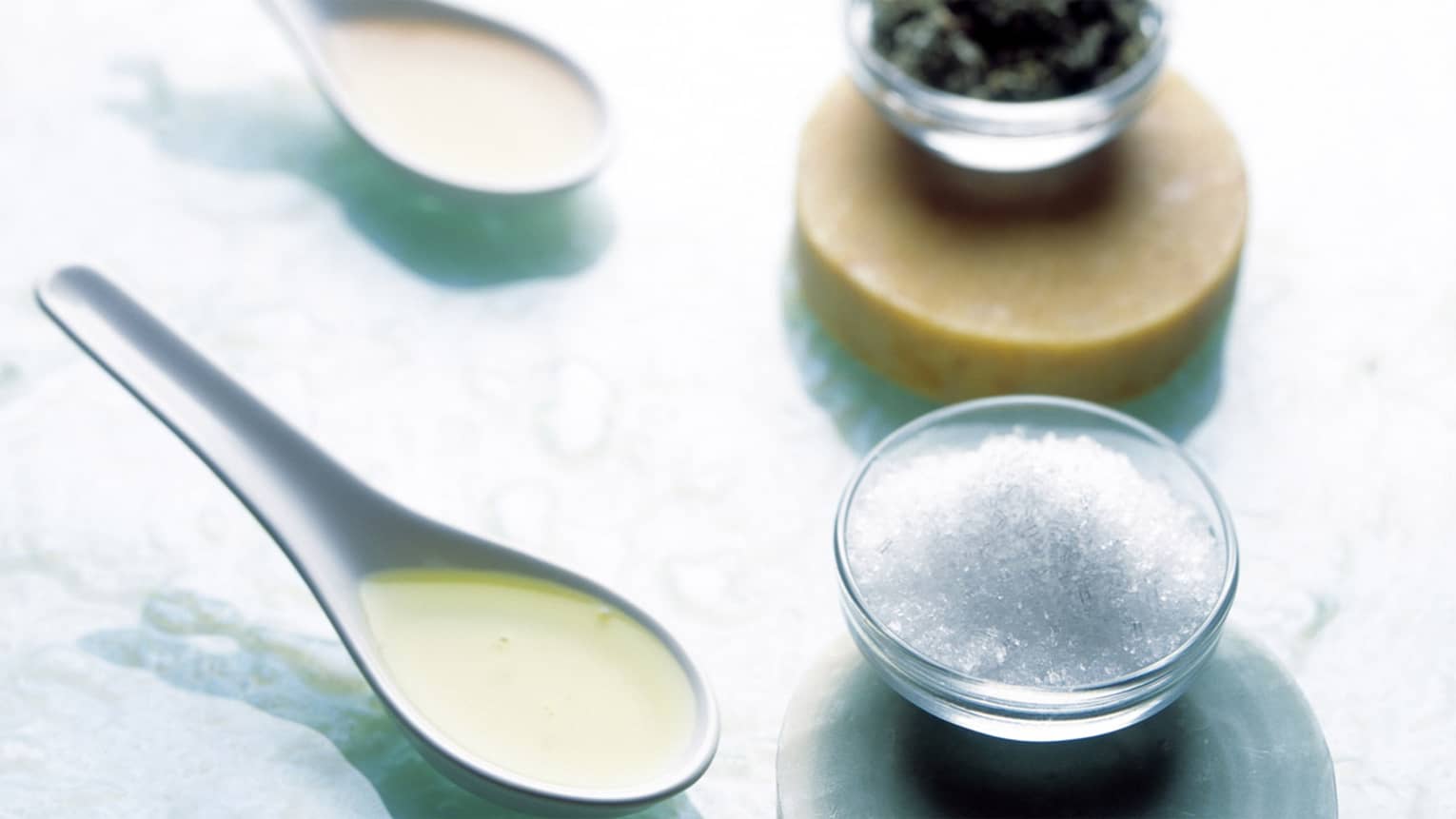 Several spices in a series of jars.