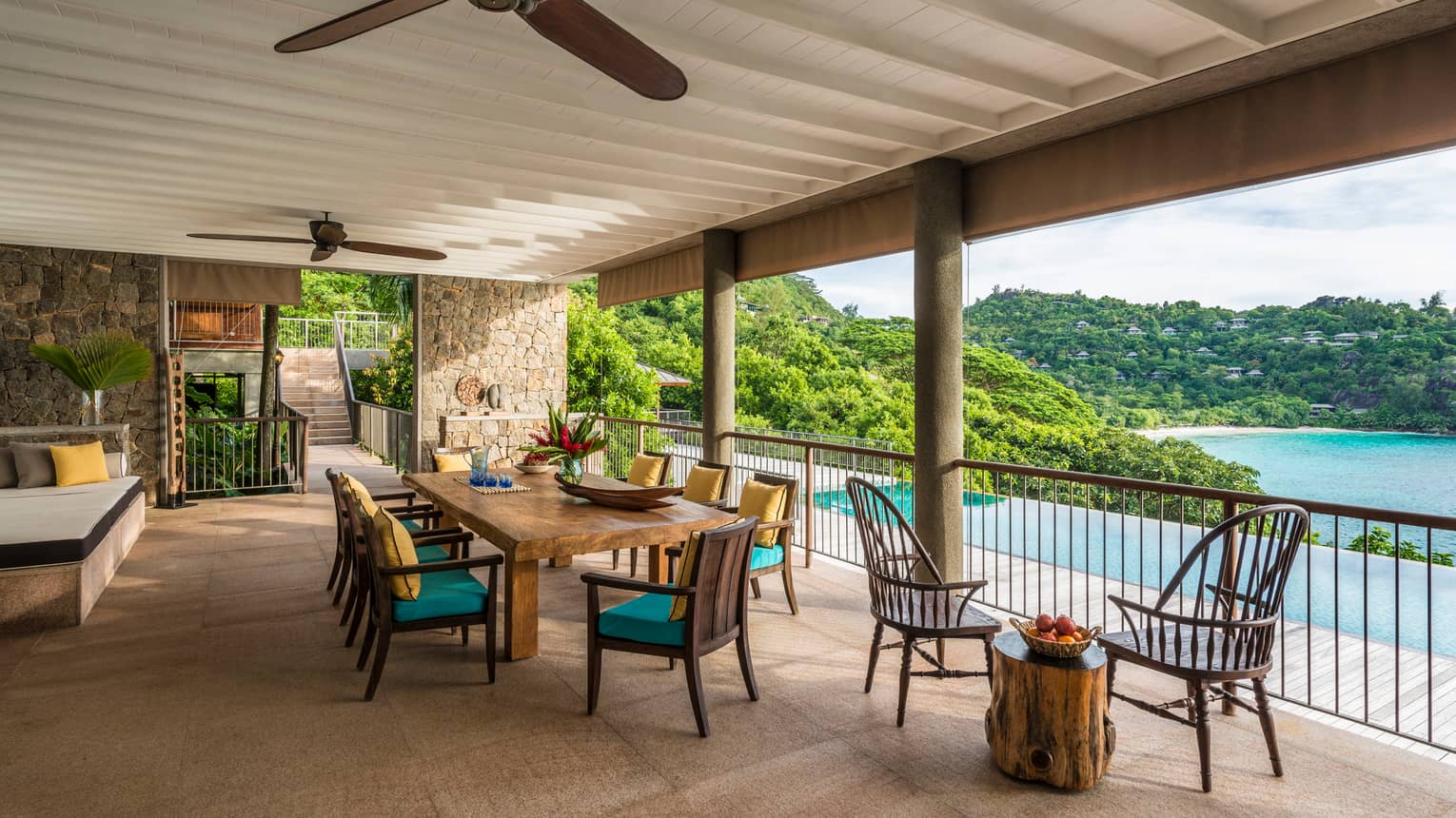 Four-Bedroom Residence Villa patio dining table, chairs under roof beside swimming pool