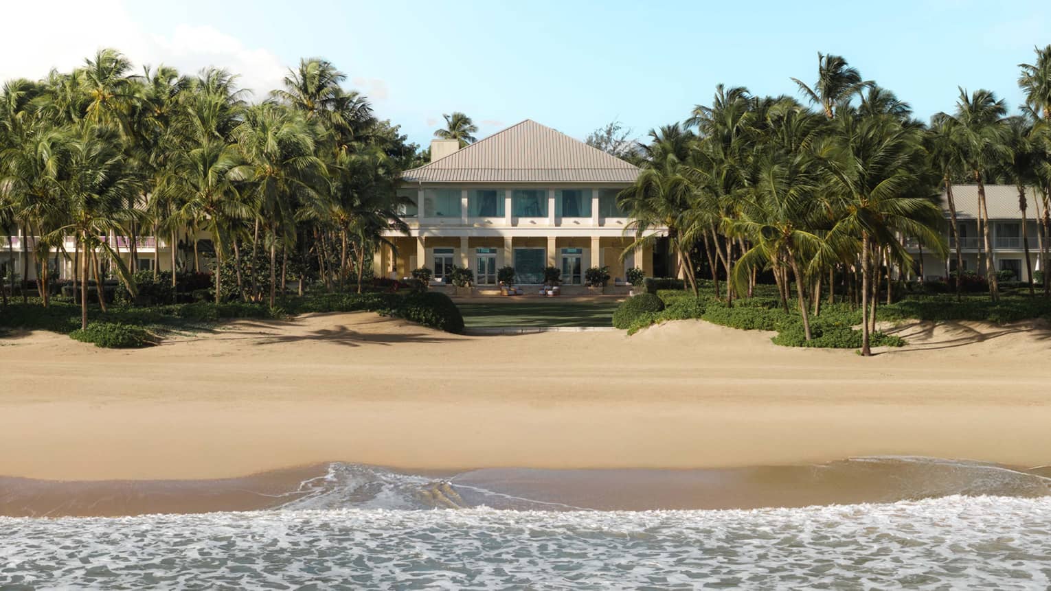 Exterior of tropical resort with beach and trees