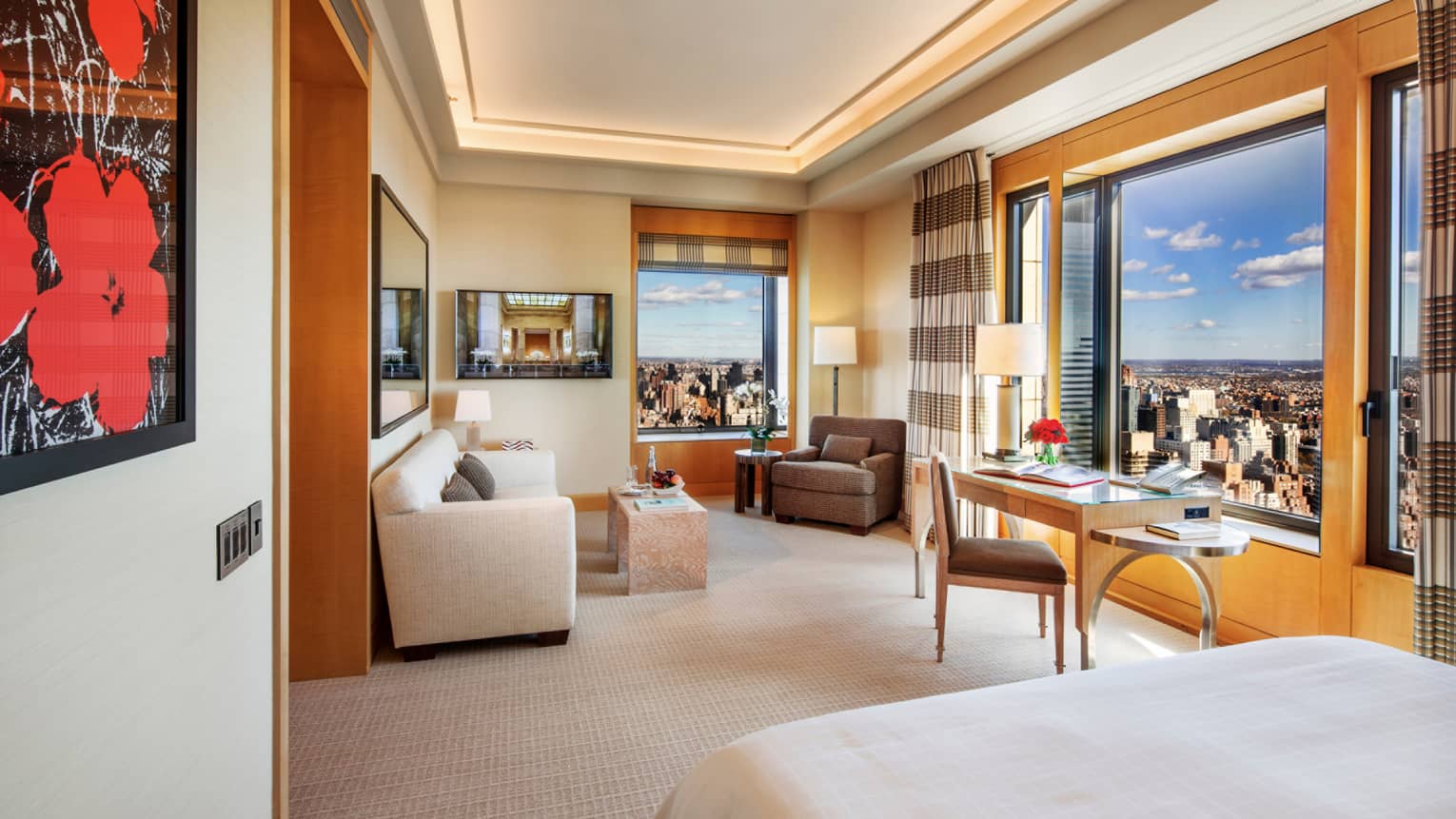 Gotham Junior Suite framed red flower print, edge of bed, seating area, desk by sunny windows