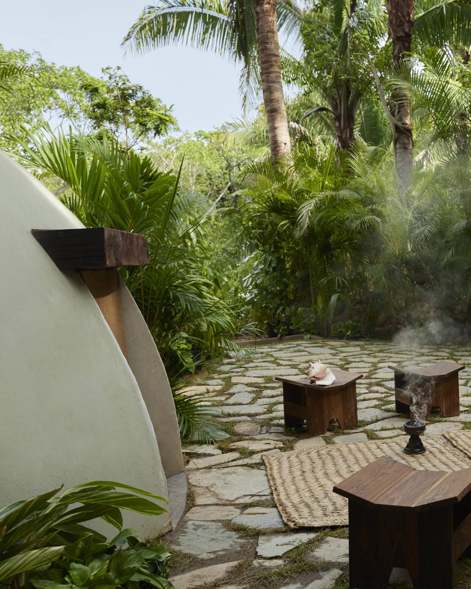 Outside a traditional temazcal or "house of heat," surrounded by lush tropical trees