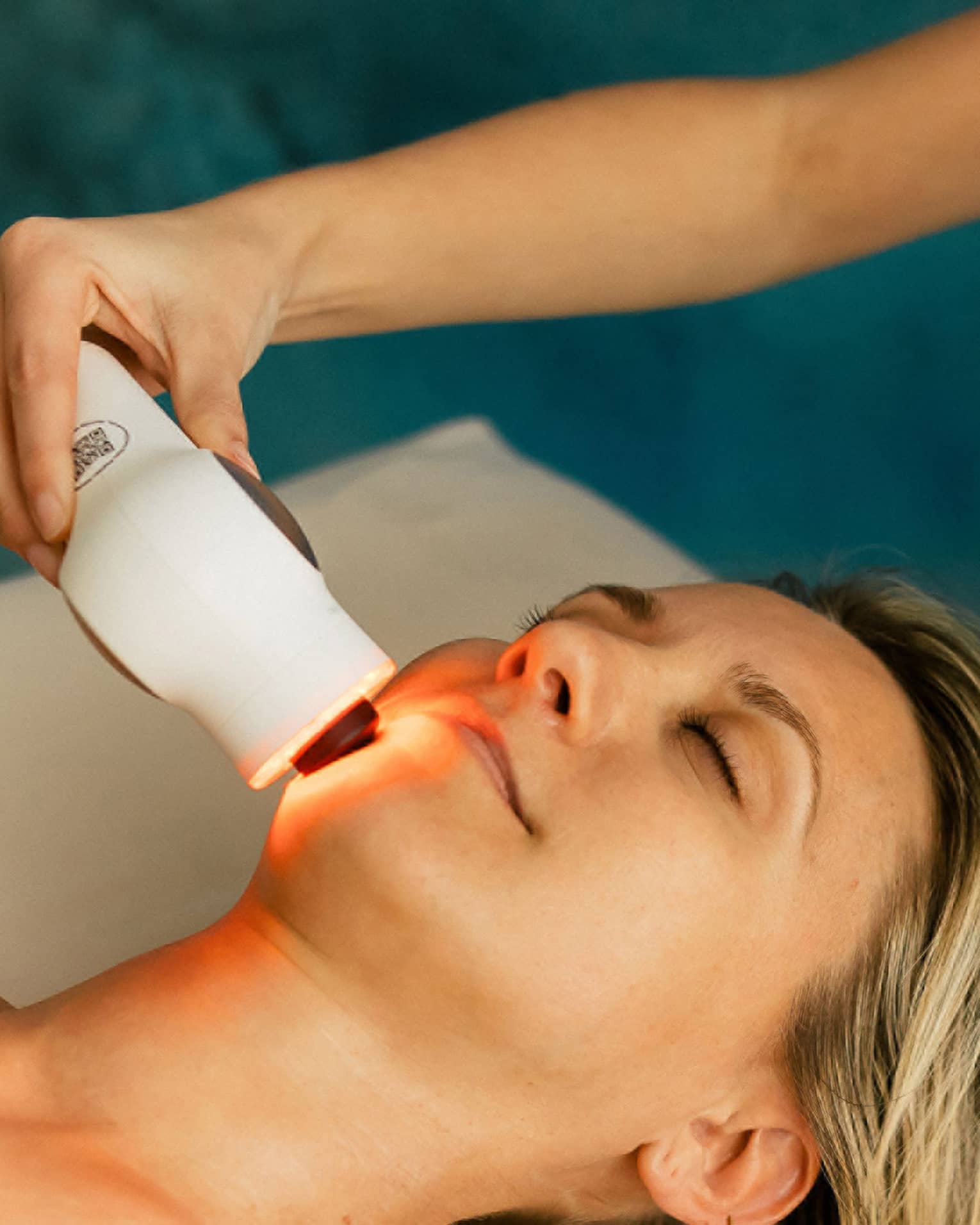 Woman gets a laser treatment on her face at a spa