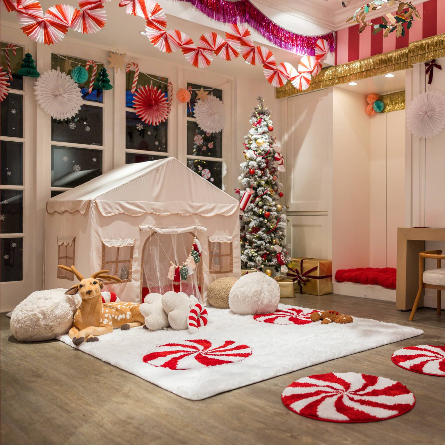 Children's tent set up beneath candy cane decorations
