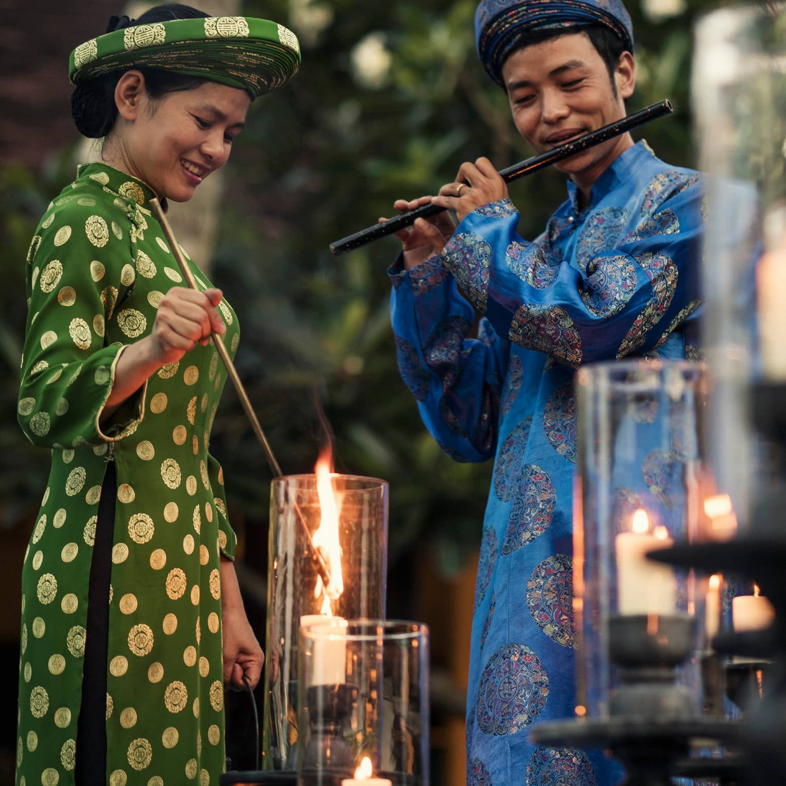 Two staff members complete the resort illumination ceremony by lighting candles with music