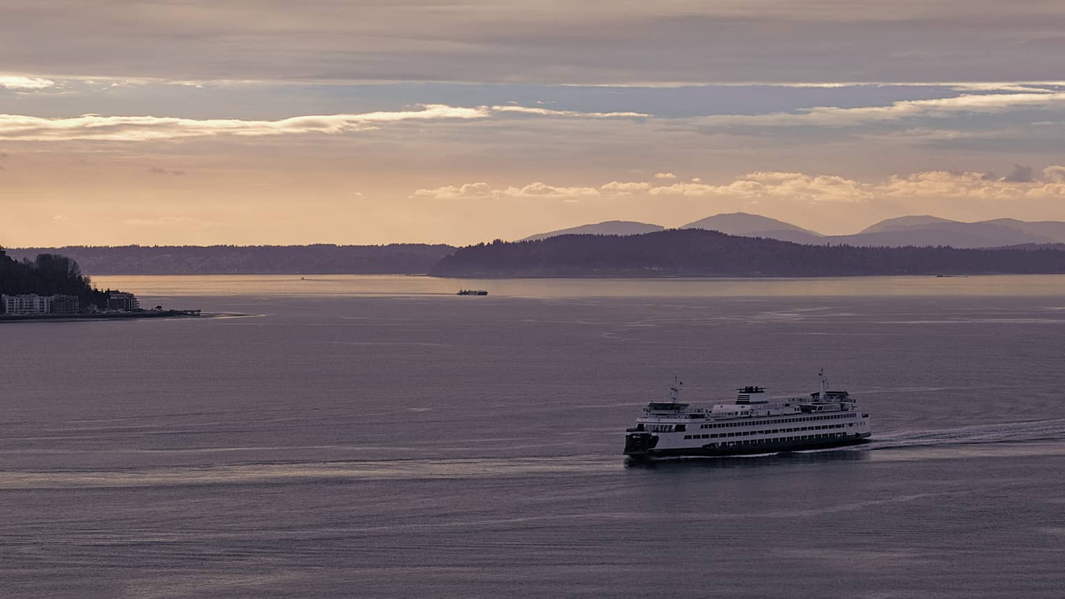 View of large ferry boat from Seattle to Victoria, B.C. sailing on ocean at sunset