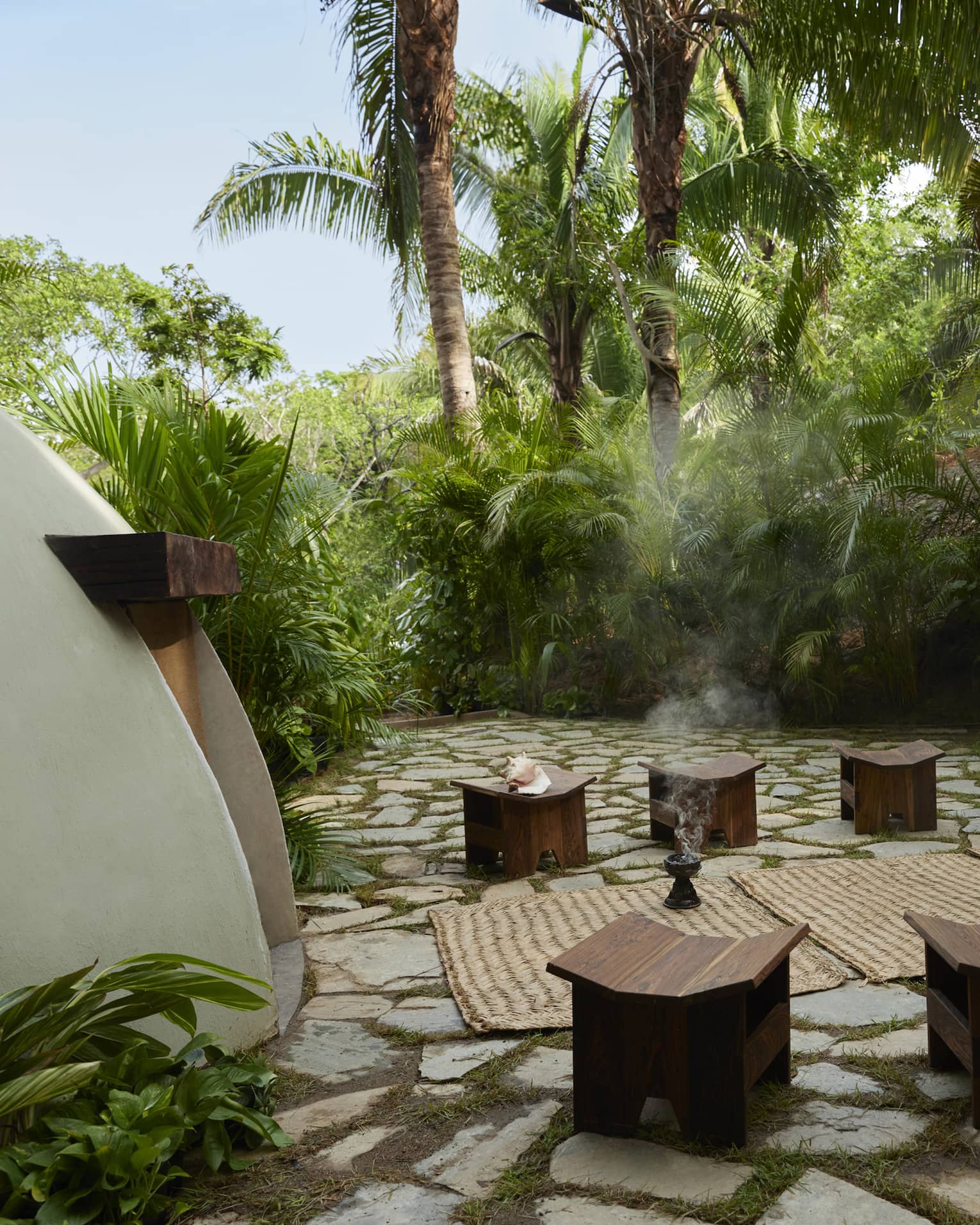 Outside a traditional temazcal or "house of heat," surrounded by lush tropical trees