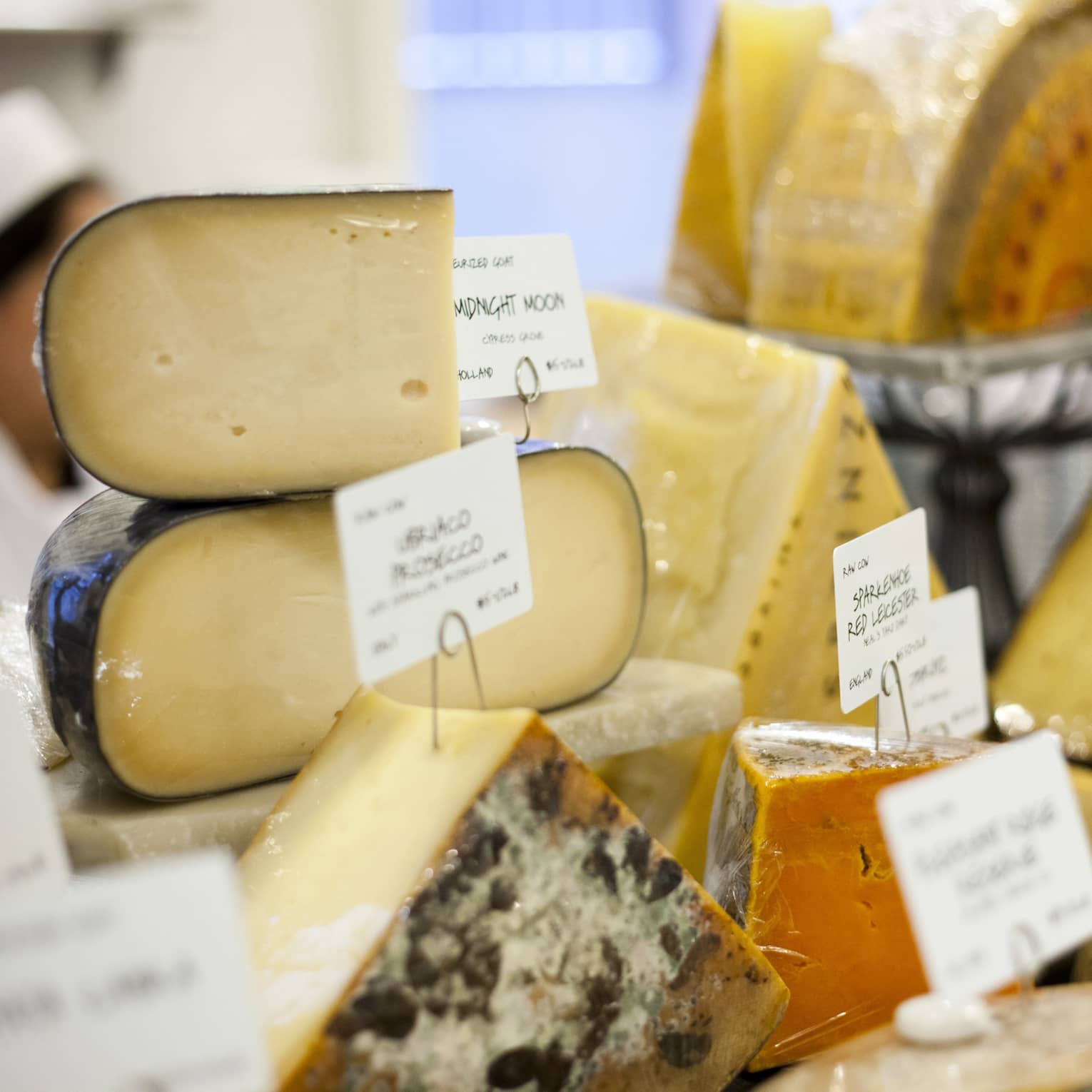 Close up of various cheeses with handwritten labels