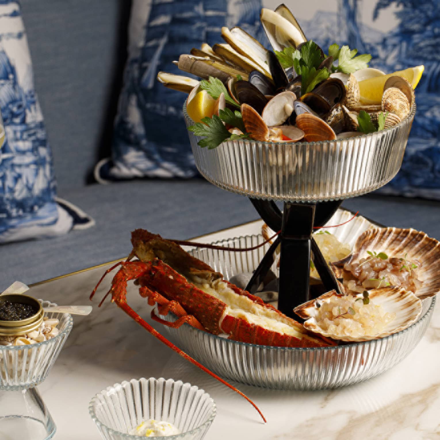 Seafood tower with mixed shellfish on marble table with caviar and champagne
