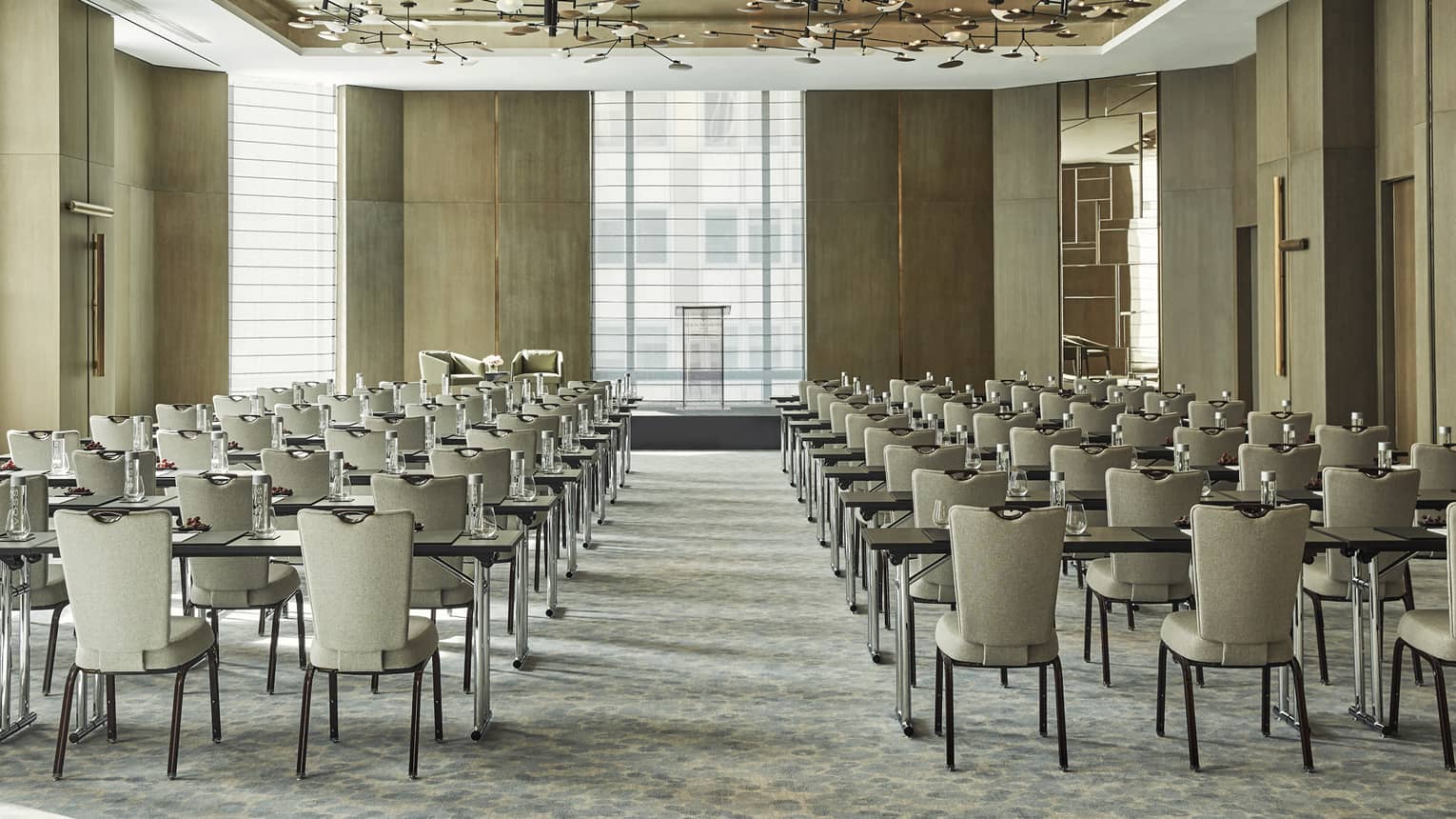 Large, bright Greenwich Ballroom with rows of meeting tables and chairs facing windows