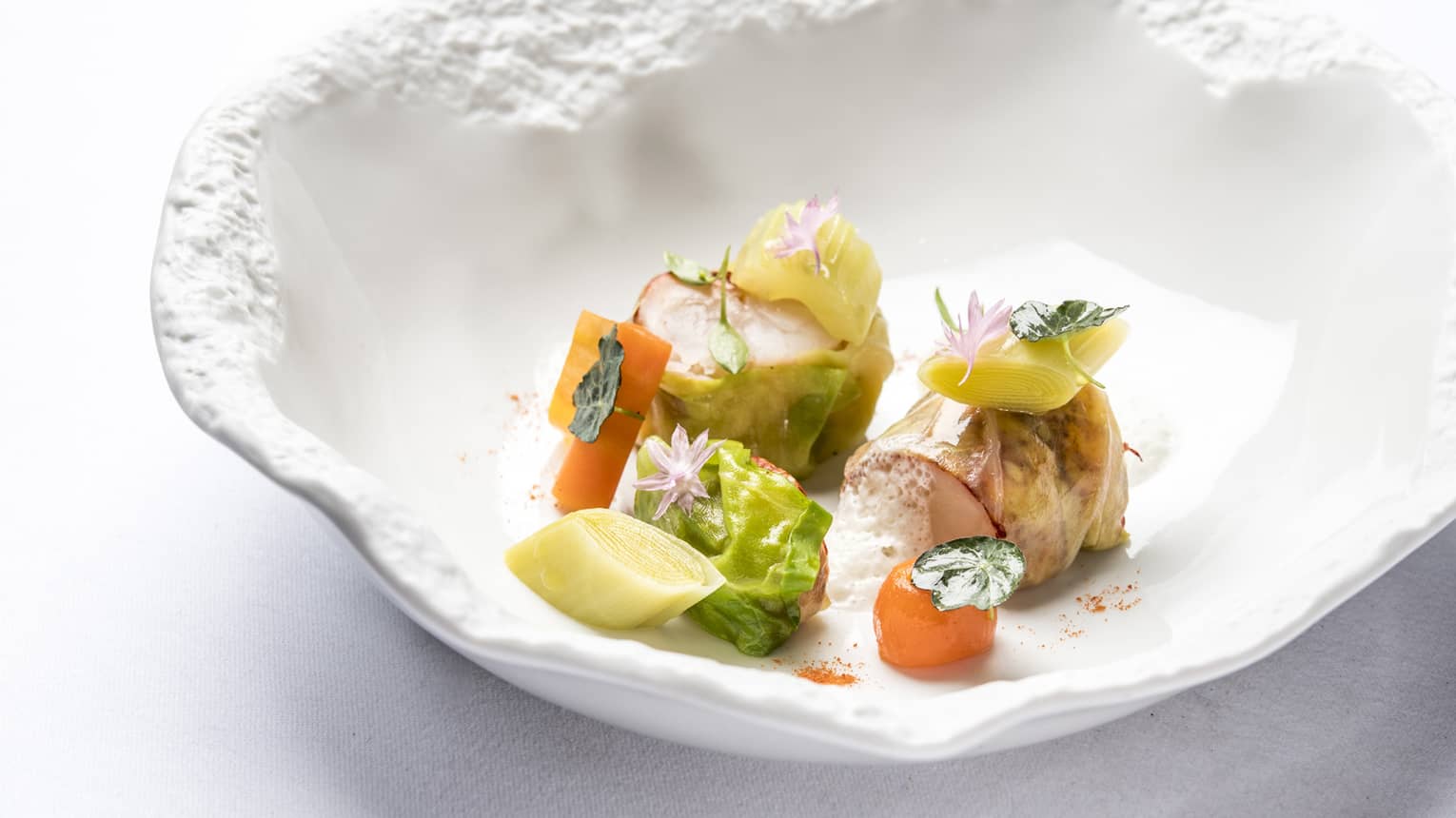 Blue Lobster Nage in artistic white bowl