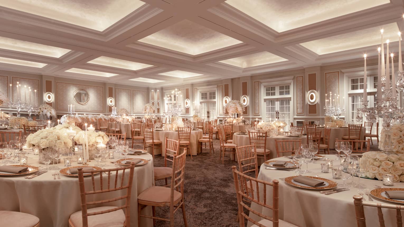 Wedding banquet tables with white linens, flowers in ballroom