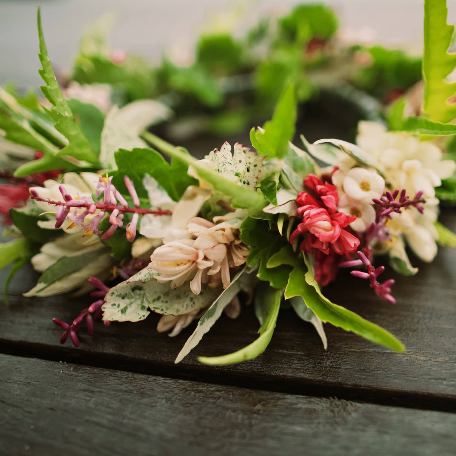 Tropical flowers arranged in floral wedding crown on table