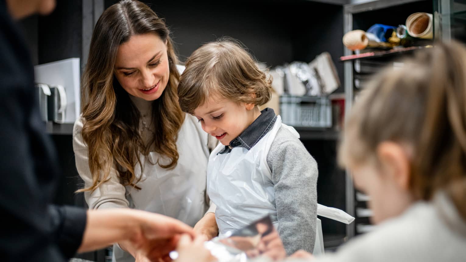 A family doing an activity in a kitchen.