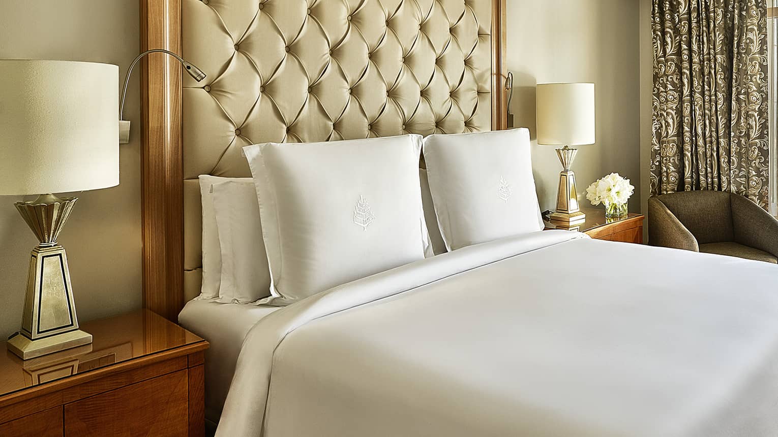Four Seasons Suite, showing white-dressed bed and city views from windows