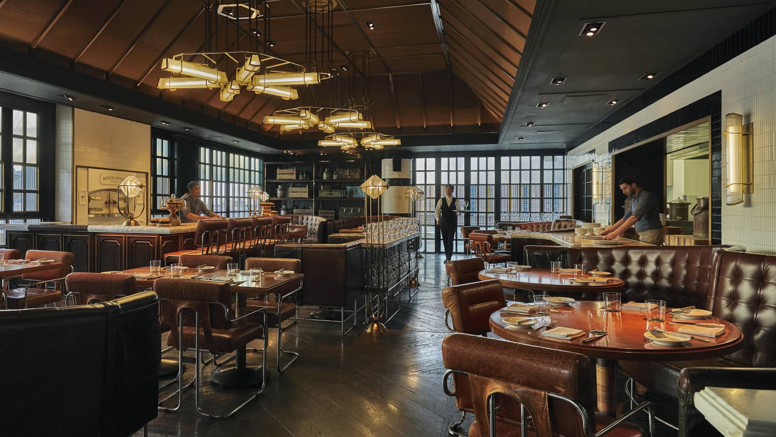 Restaurant and bar with brown leather seats and sofas, bar stools and contemporary lights
