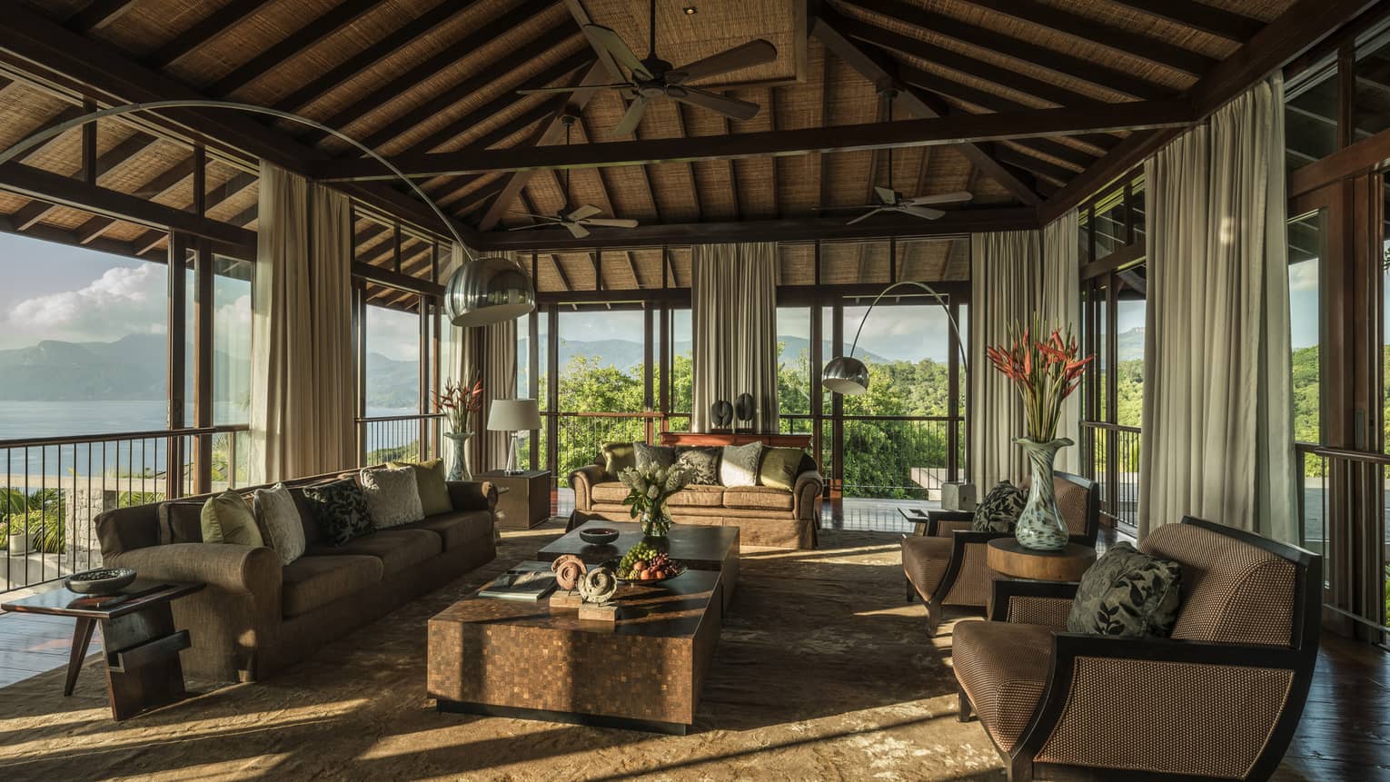 Five-Bedroom Residence Villa open-air living room sofas, armchairs, tables under wood-beam roof