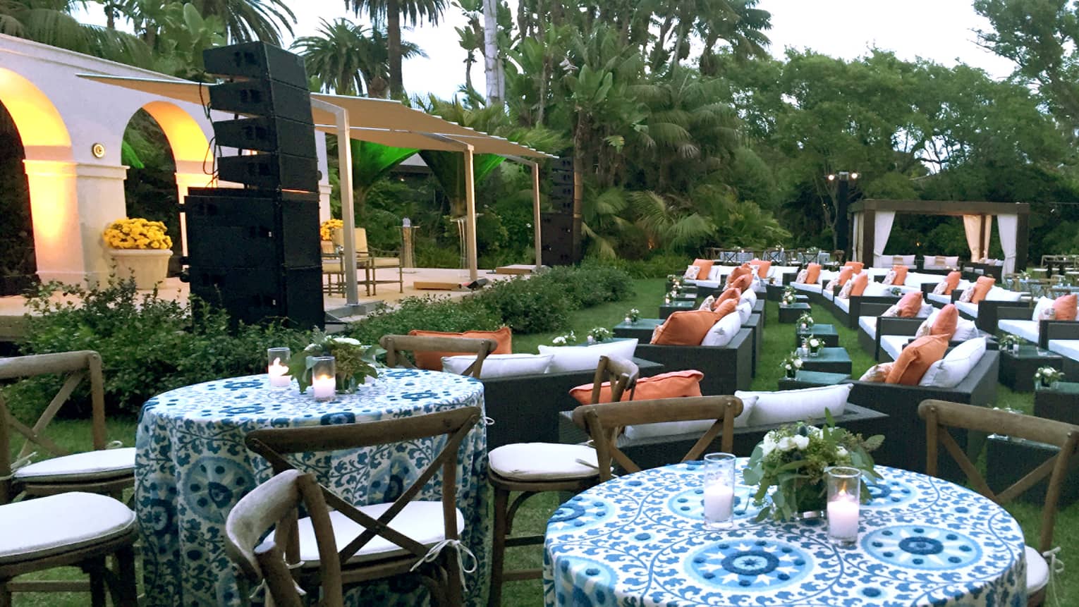 Garden banquet on Monte Vista lawn, tables and patio sofas facing stage