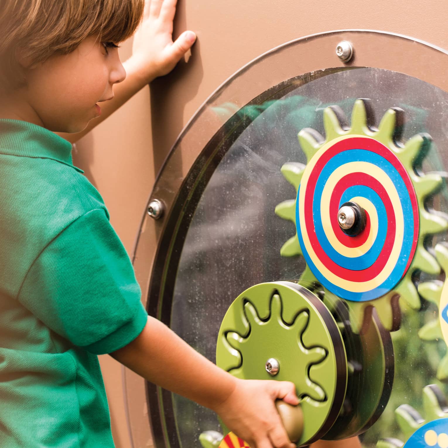 Young boy spins colourful wheel in Discovery Children's Museum