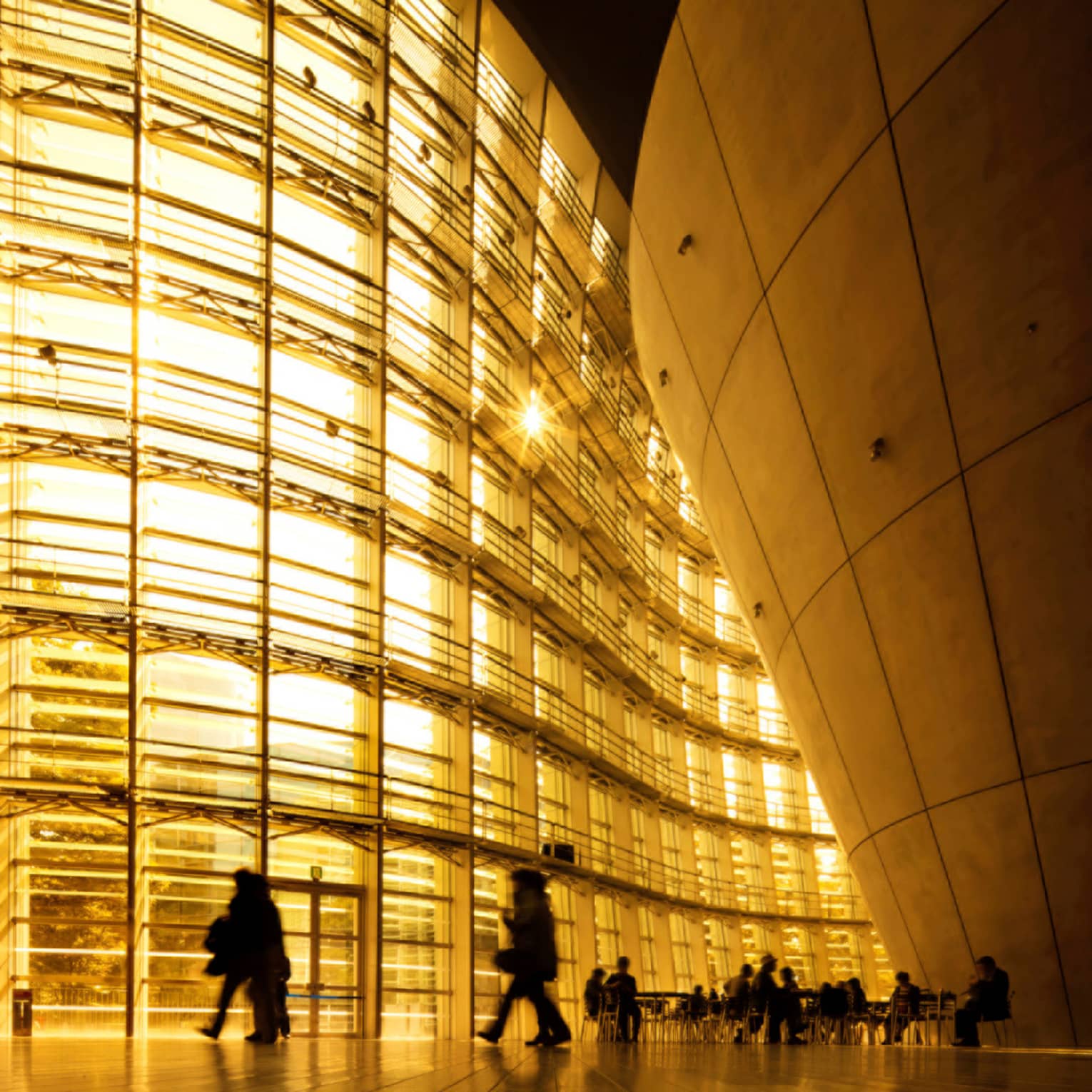 People on their daily commute to work next buildings by architecture Kengo Kuma