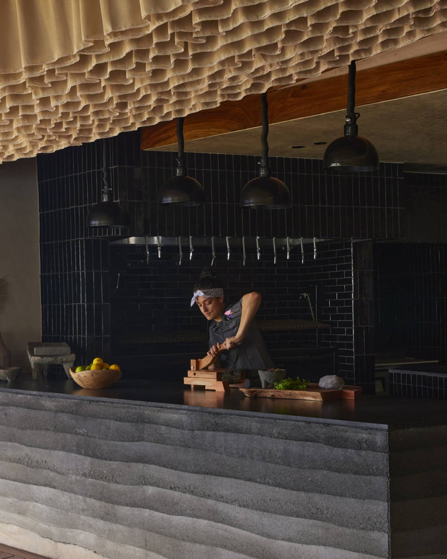 Chef Sofia works behind a counter in restaurant