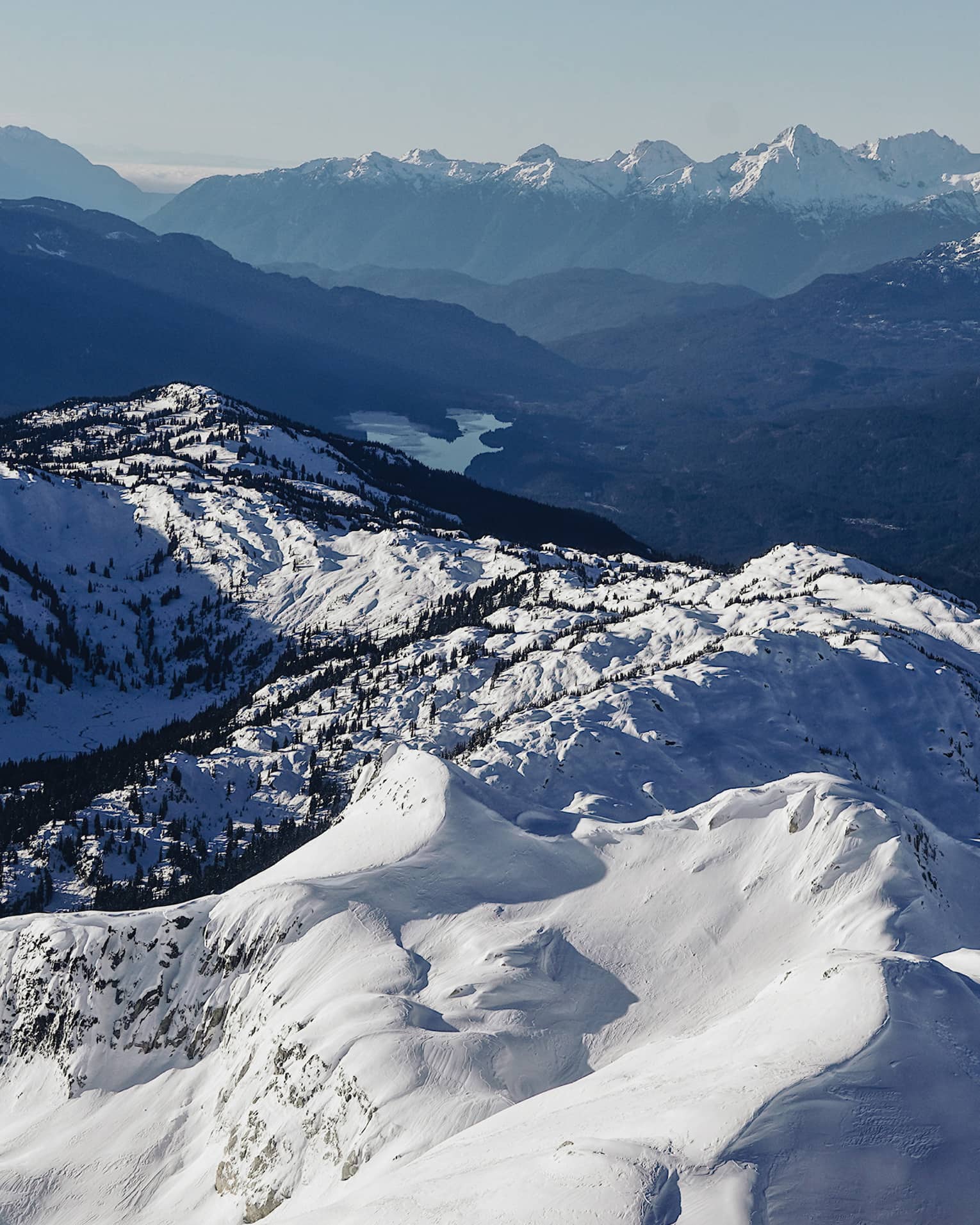 Summit view of snow-covered Coast Mountains