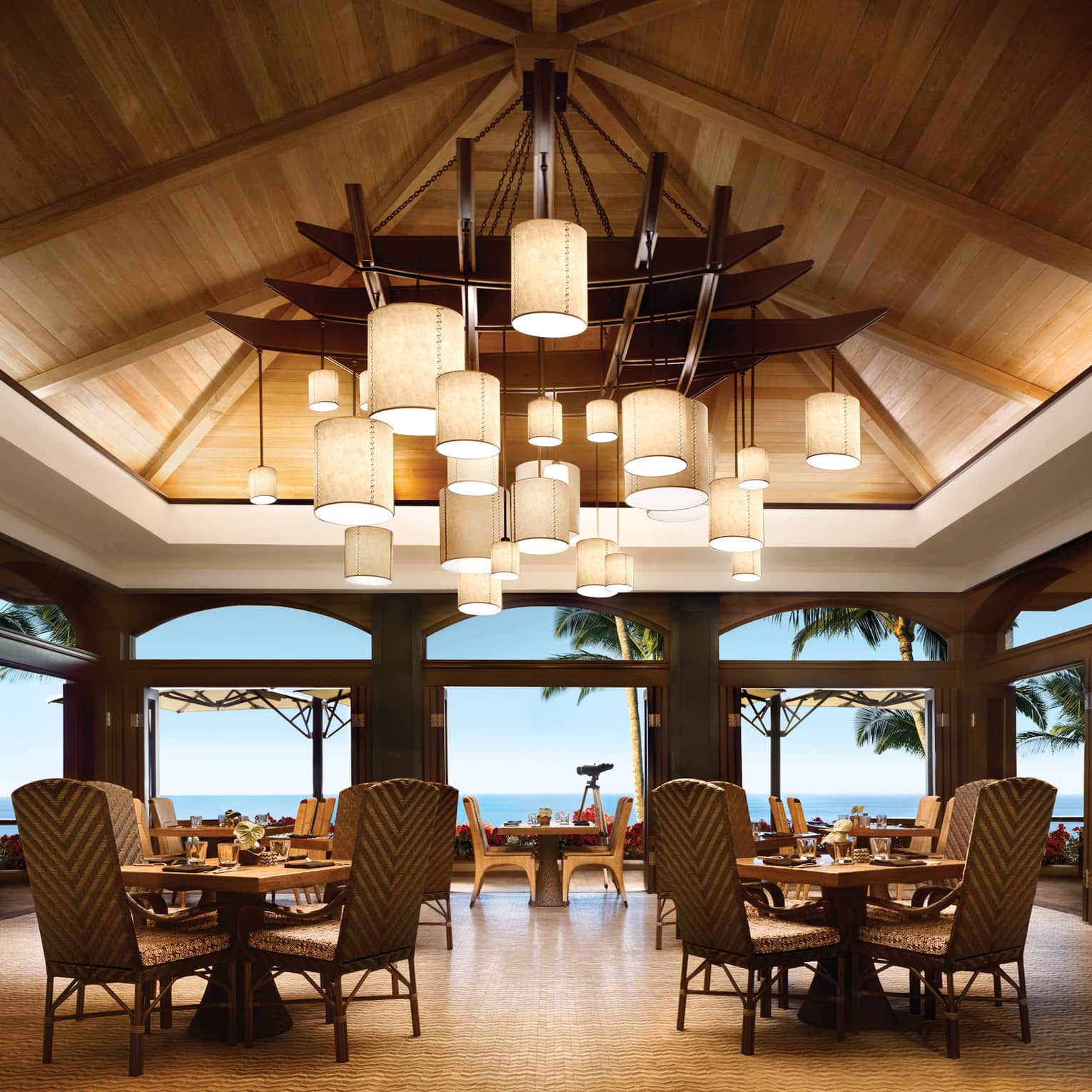 Views Restaurant dining room, tables and chairs under vaulted ceilings with modern lanterns