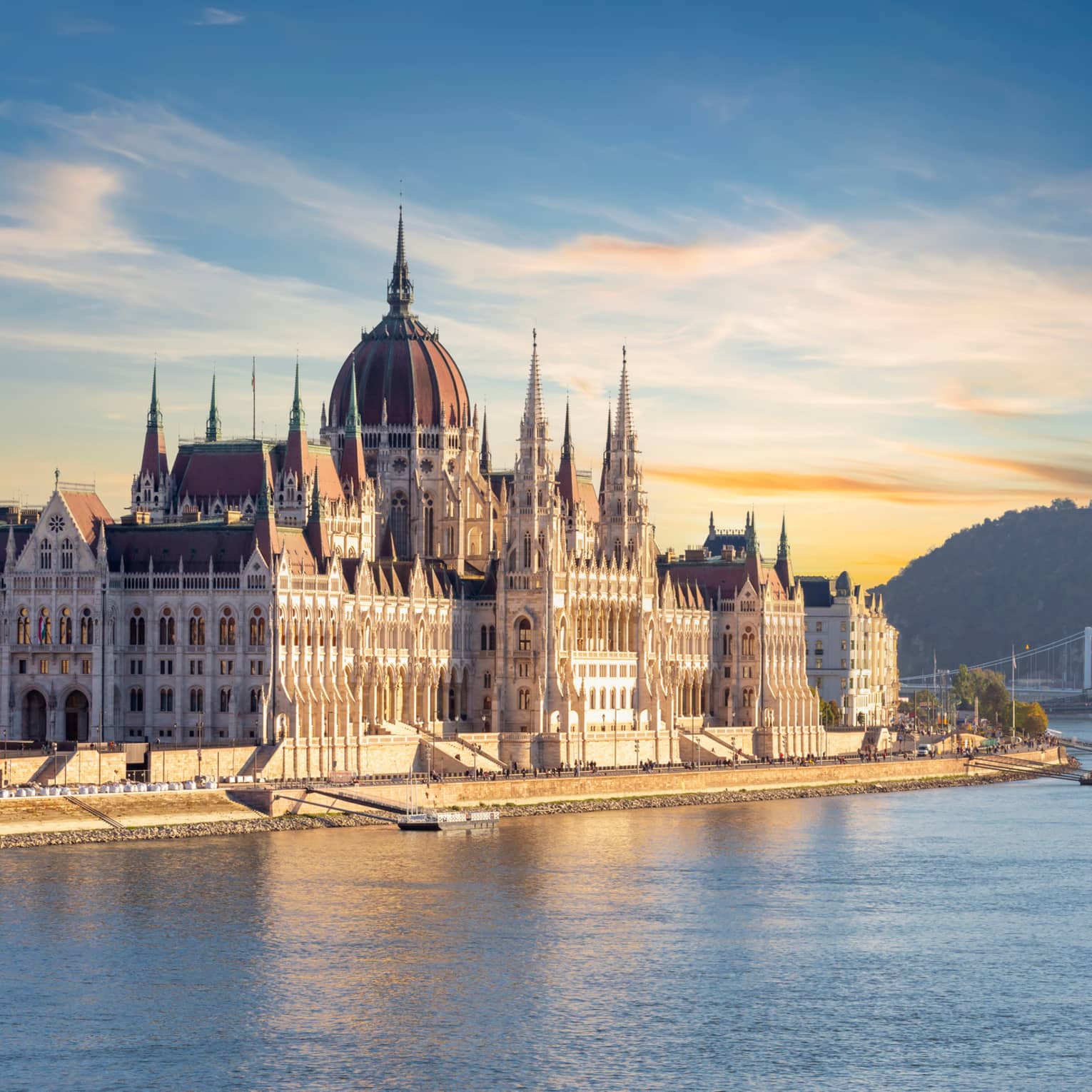 A large castle or palace on the edge of water.