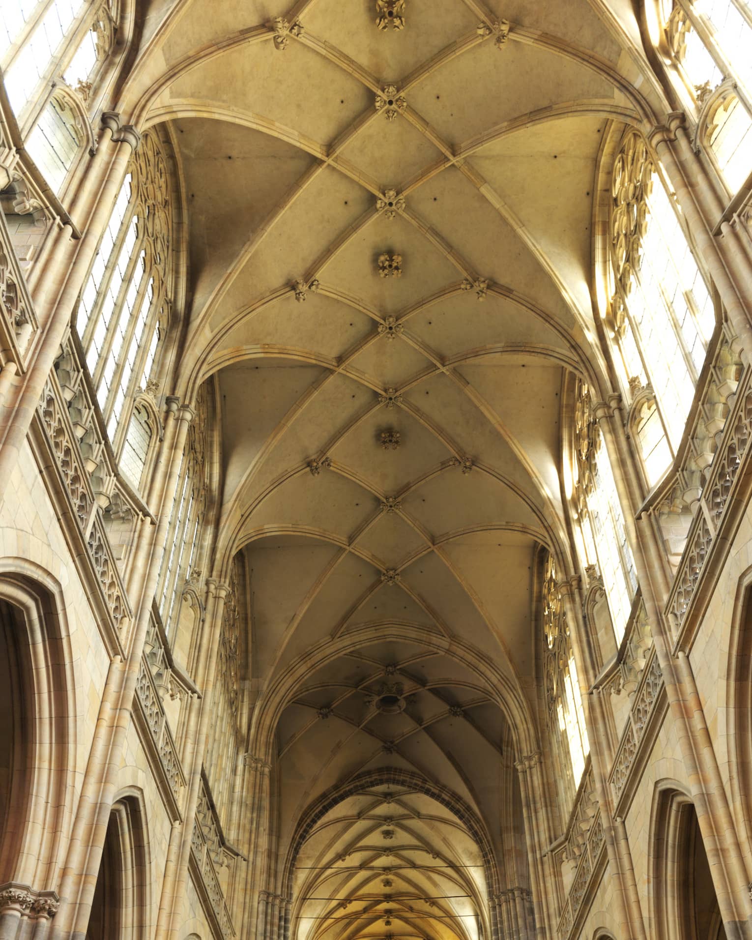 The inside of an ornate building with tall ceilings, columns and stained glass windows