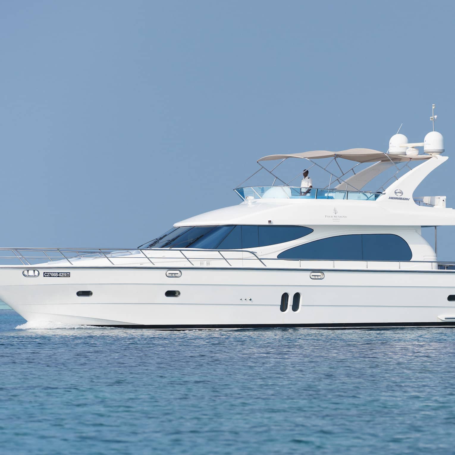 Small white private luxury yacht sailing on ocean