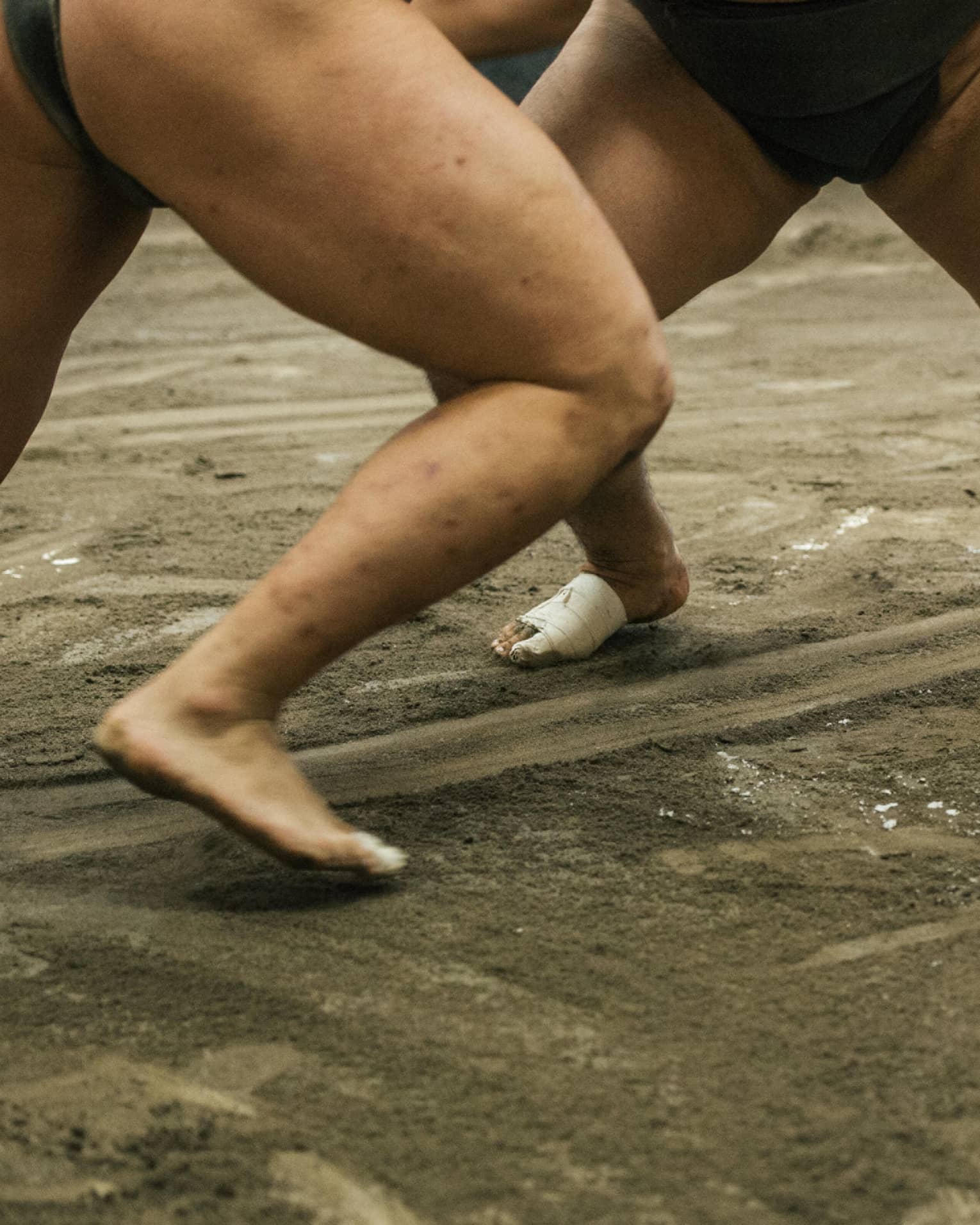 Two sumo wrestlers participate in a match