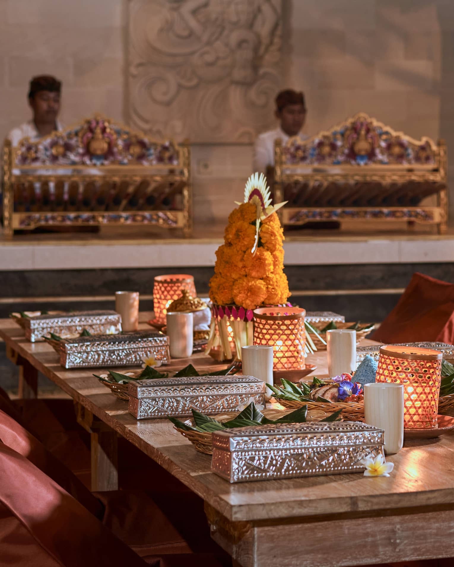 Rectangular table set with traditional Balinese adornments and candles for the Temple Ground Dinner