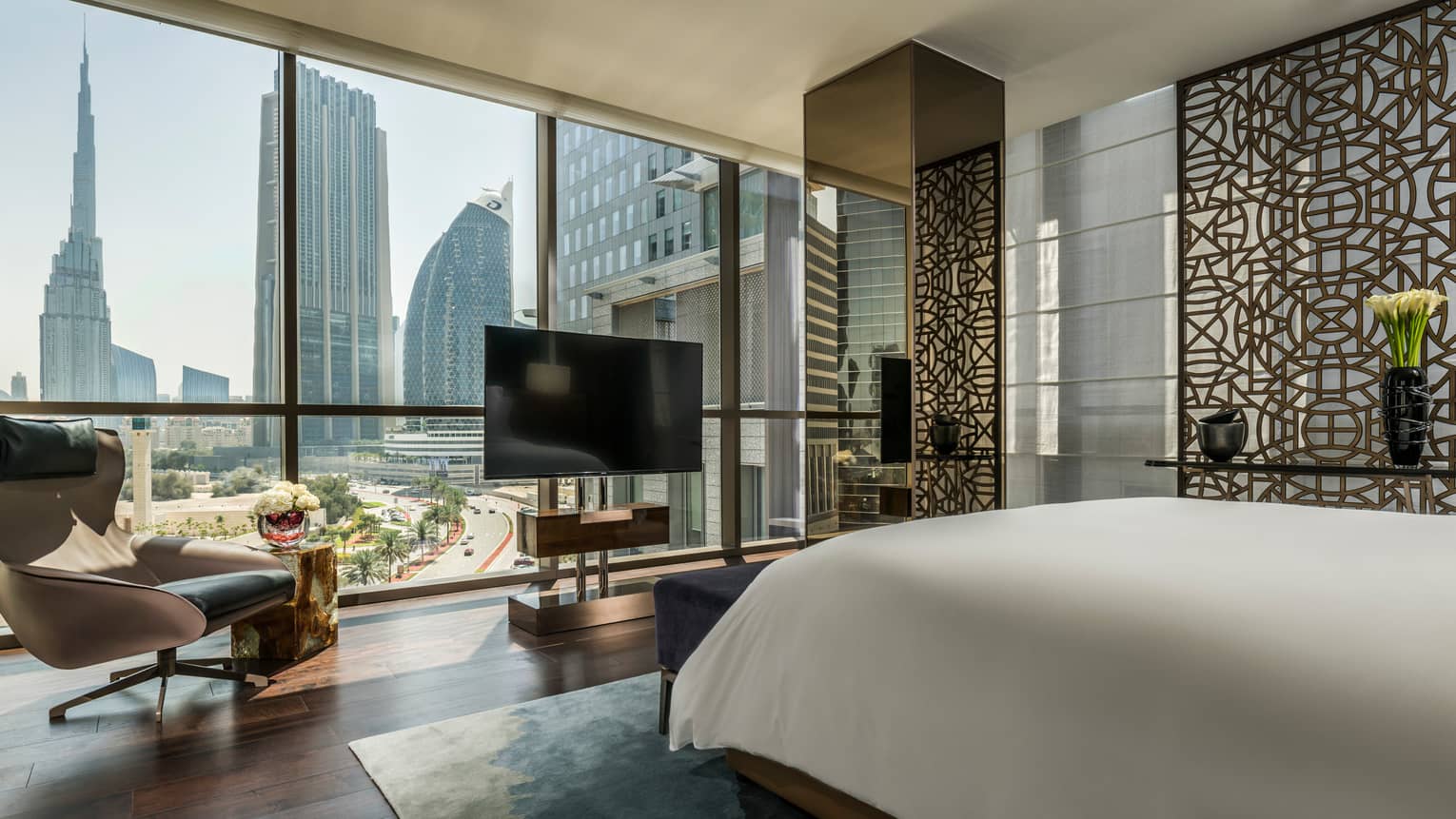 Four Seasons Deluxe Executive Suite room with bed, floor-to-ceiling window with Burj Khalifa view