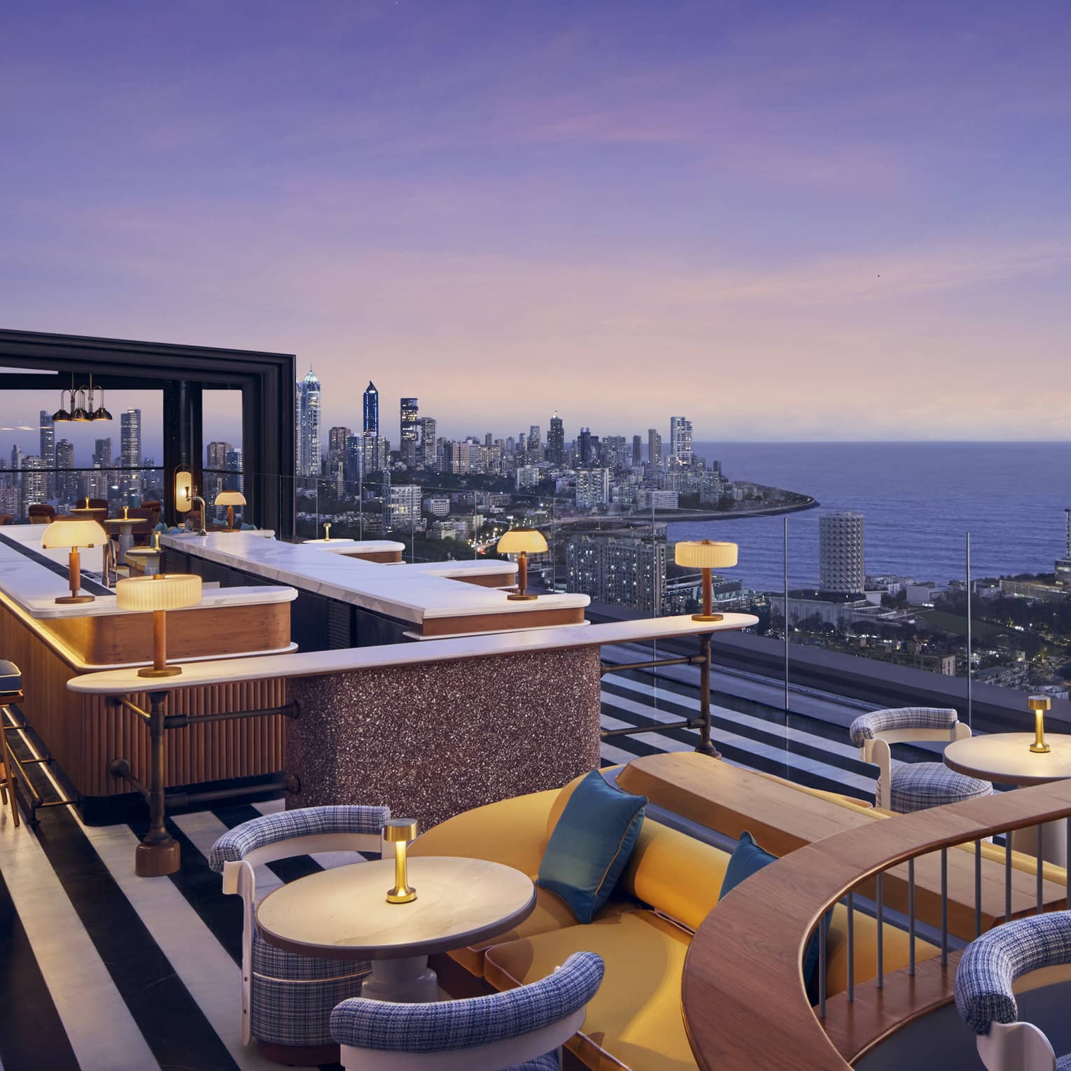 AER rooftop lounge at dusk with views of Mumbai skyline