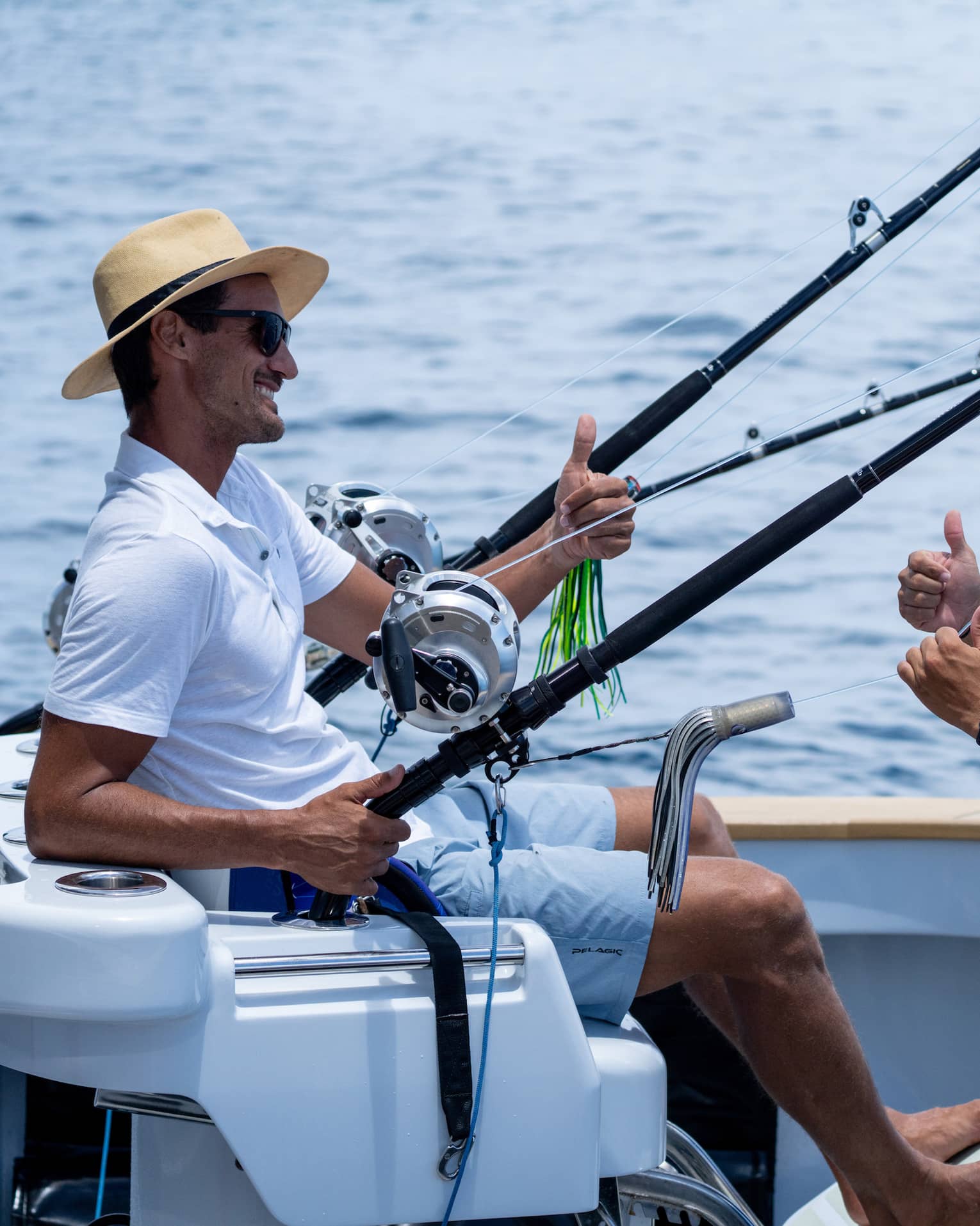 Two men talk on a fishing boat at sea