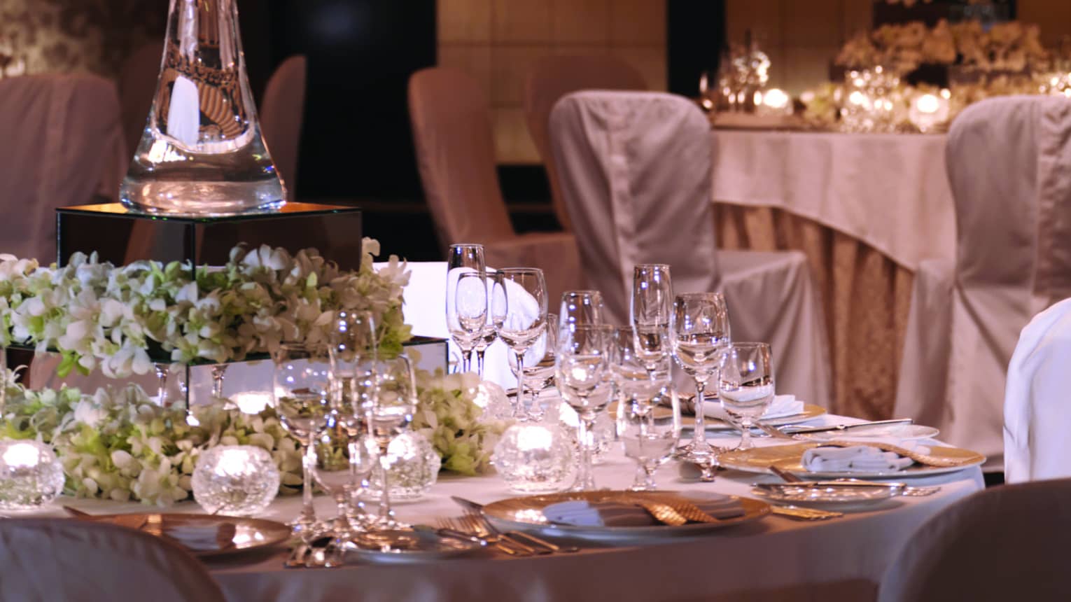 Tall vase with white flowers on banquet dining table