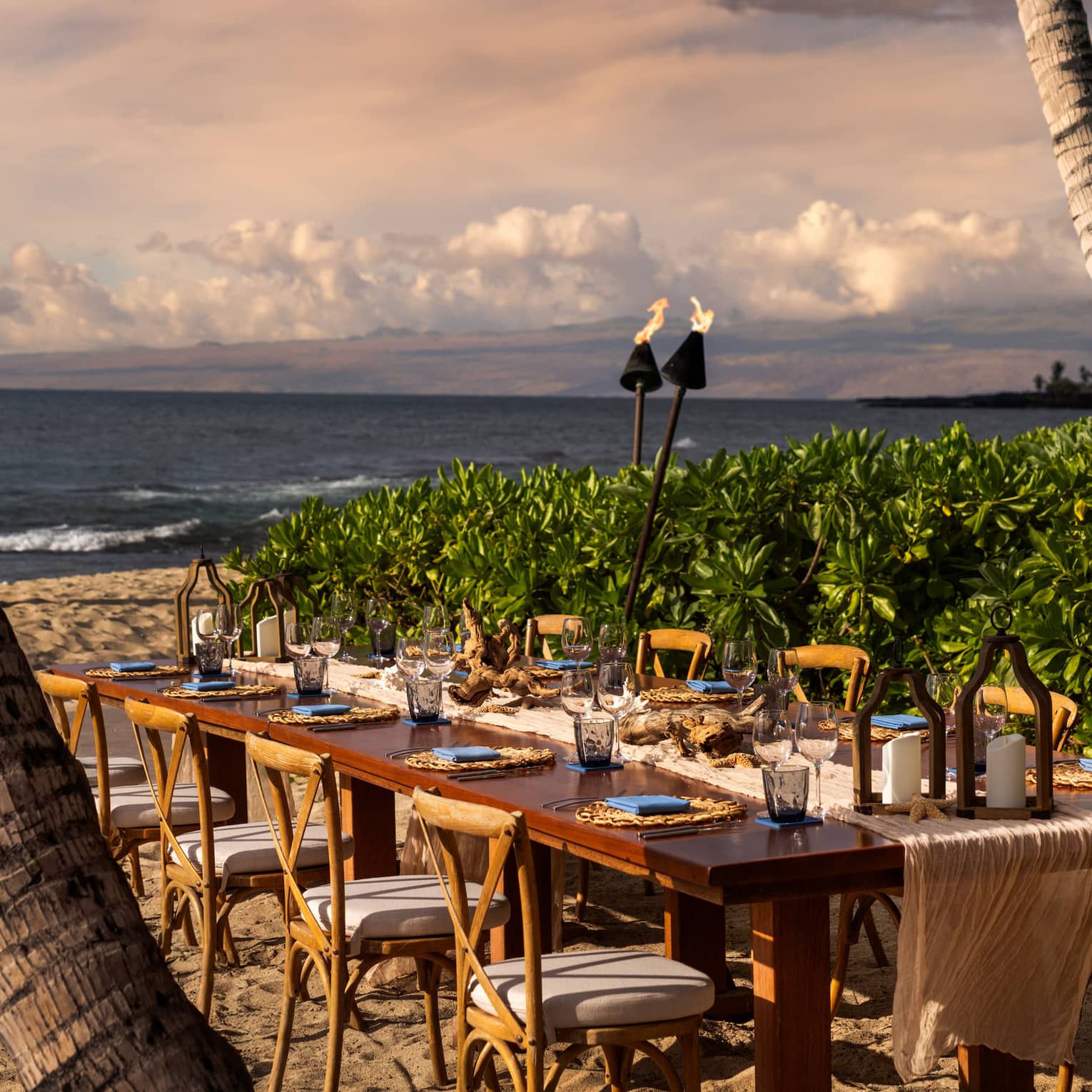 Private dining table seating 10 on the beach in tropical settig