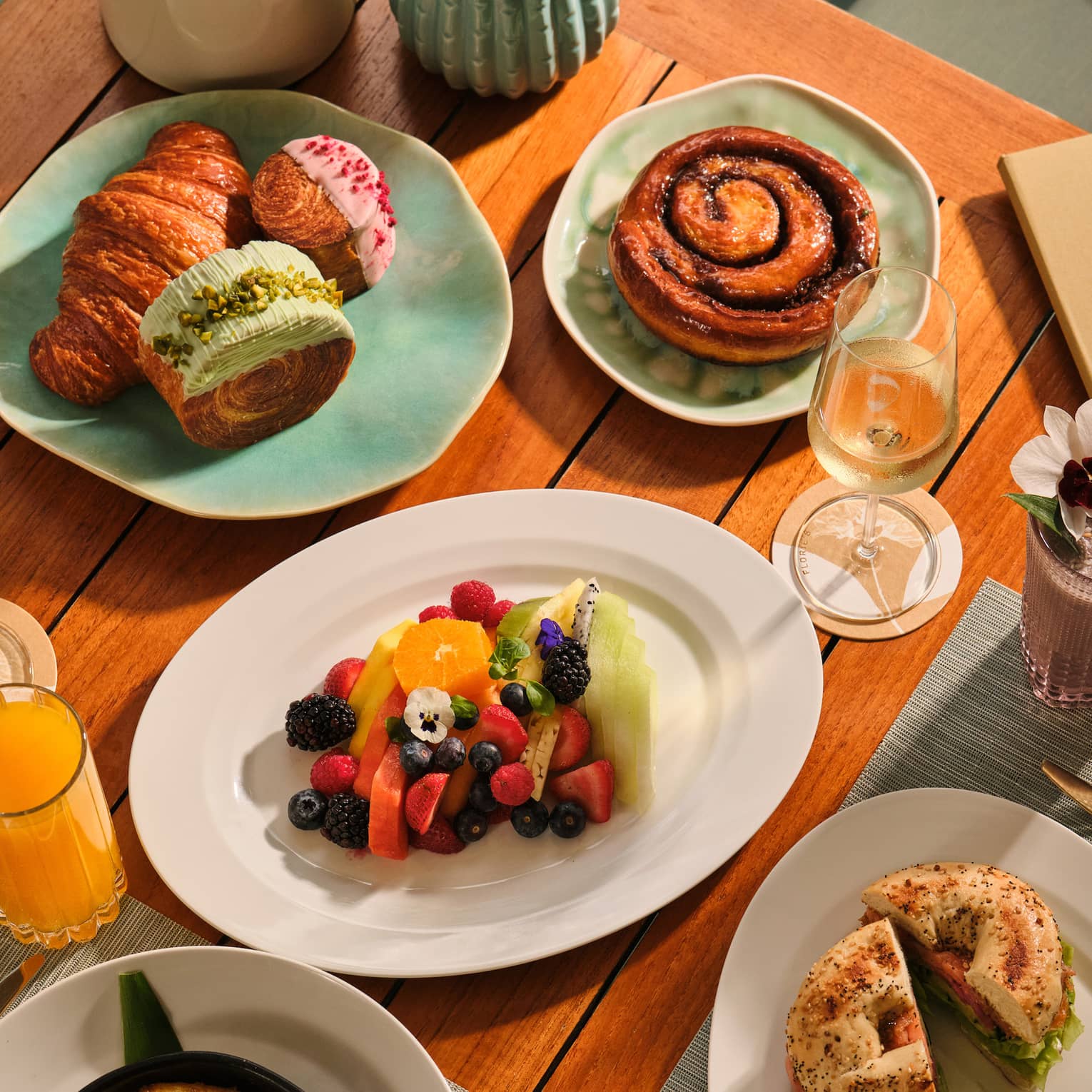 Outdoor table filled with a variety of breakfast dishes