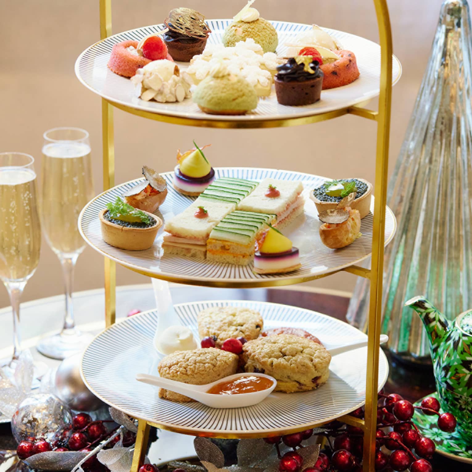 A three-tier tray of afternoon tea sweets.